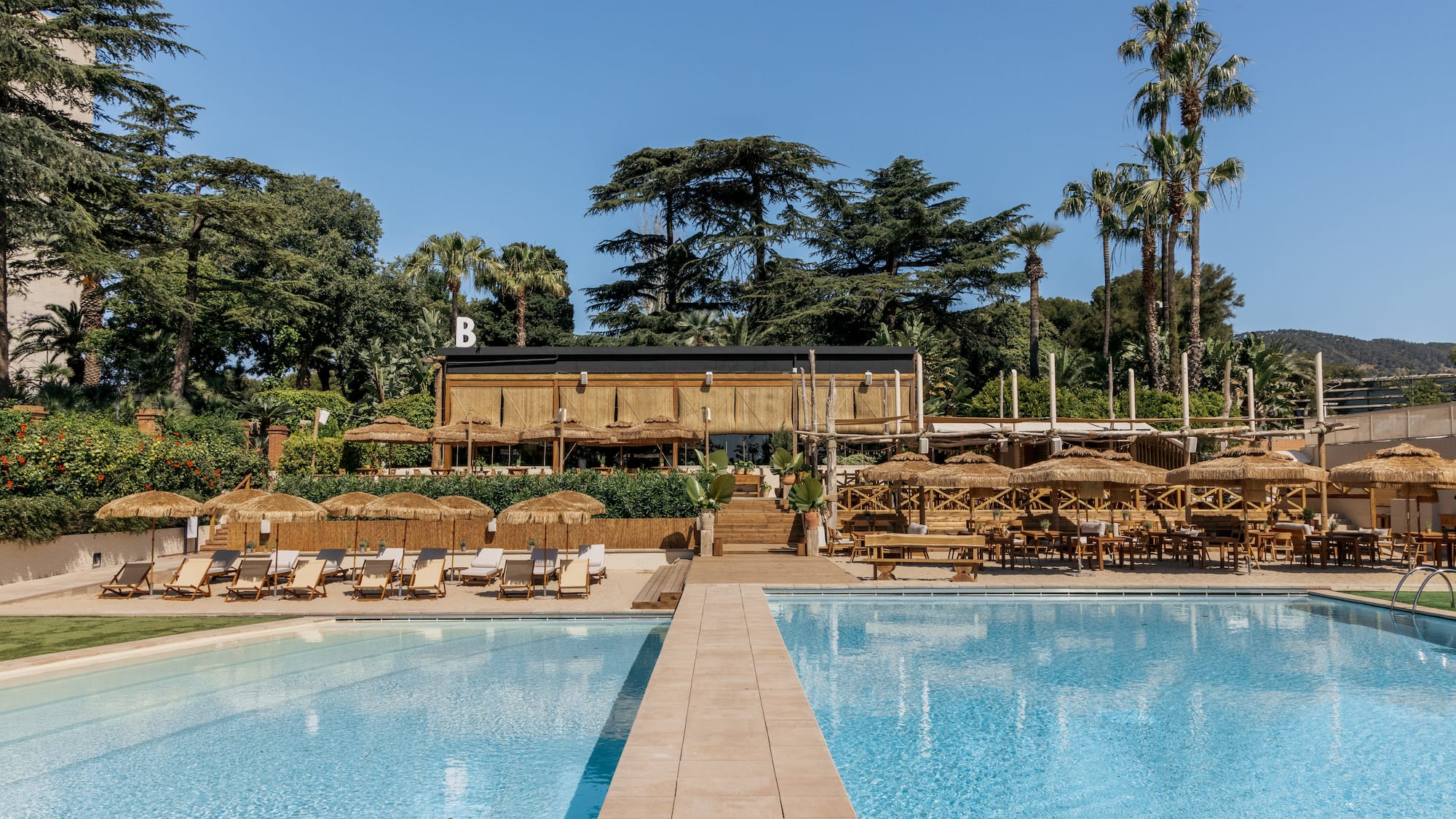a pool with chairs and umbrellas