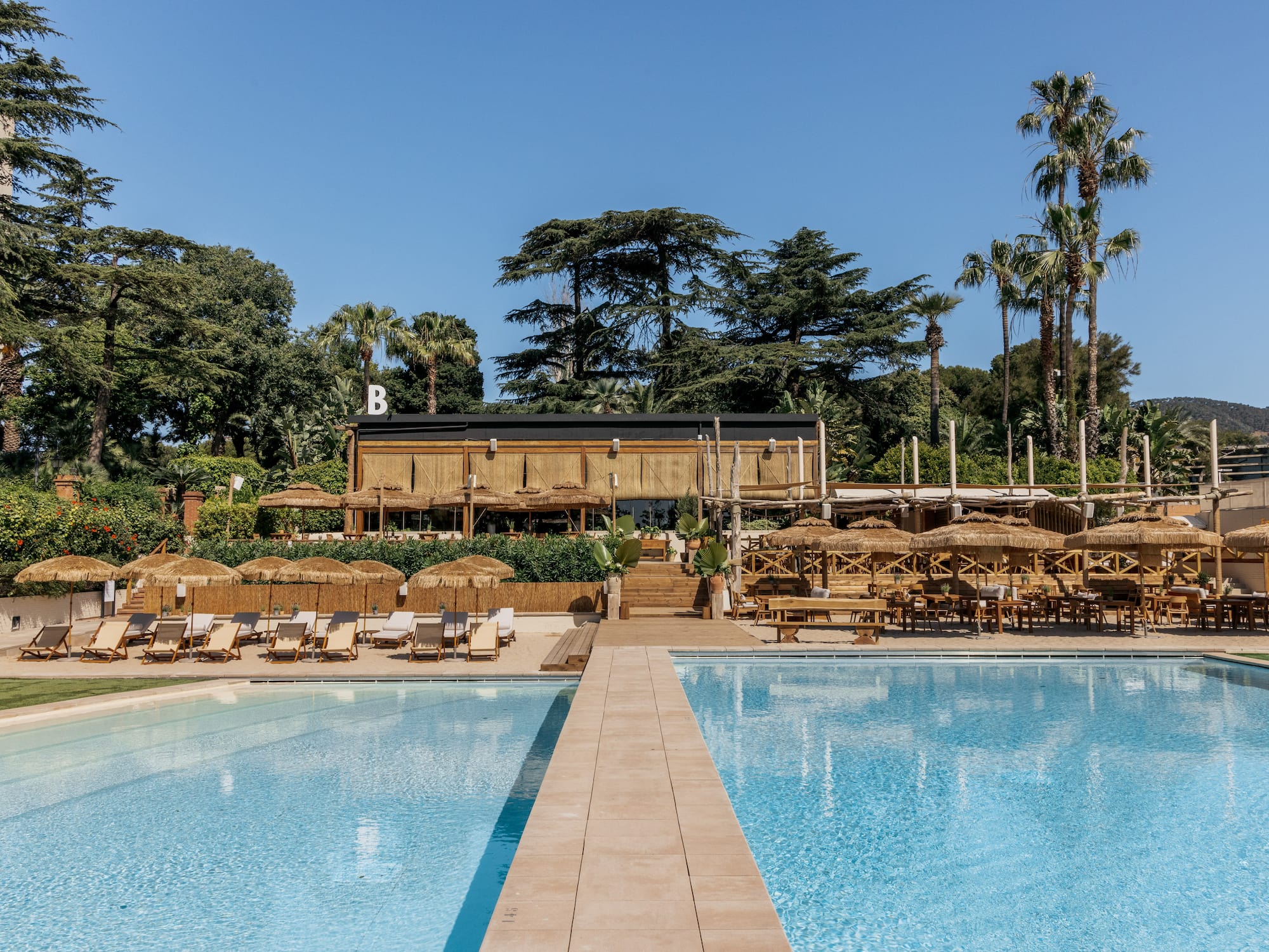 a pool with chairs and umbrellas