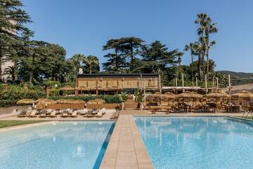 a pool with chairs and umbrellas