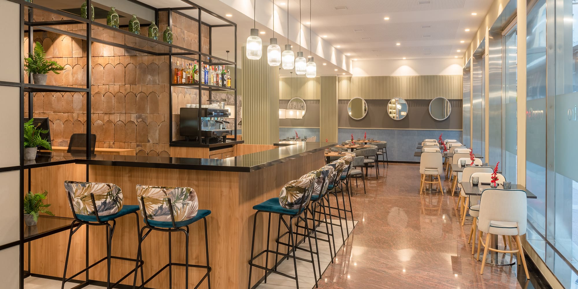 a room with a bar and chairs