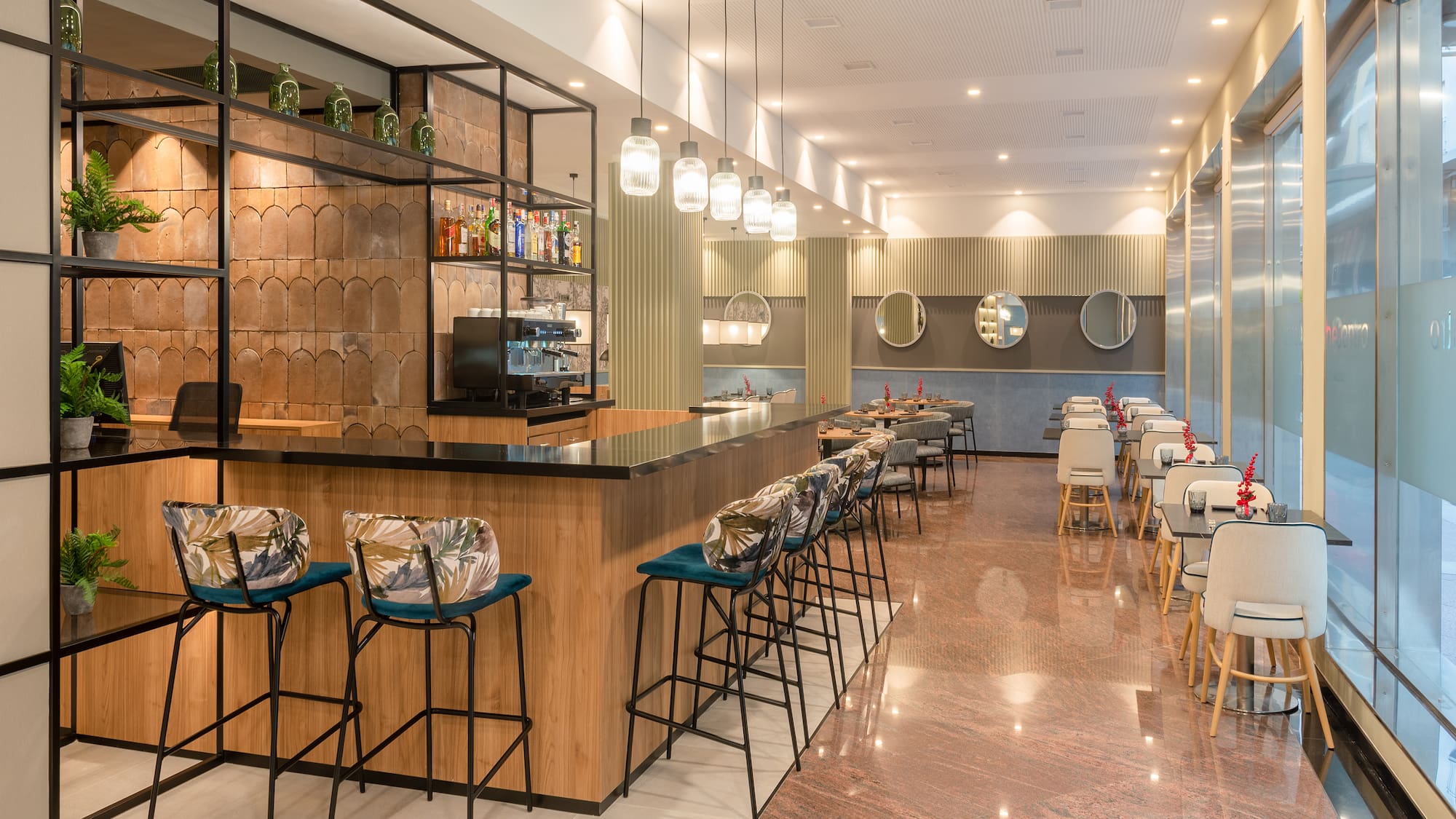 a room with a bar and chairs