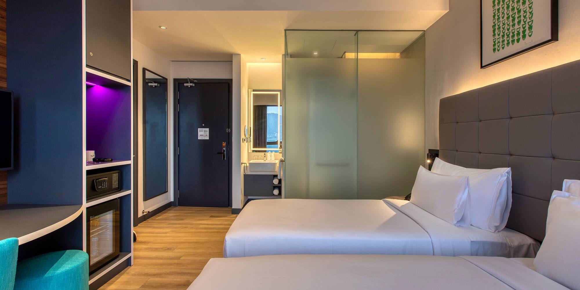 a room with two beds and a glass door