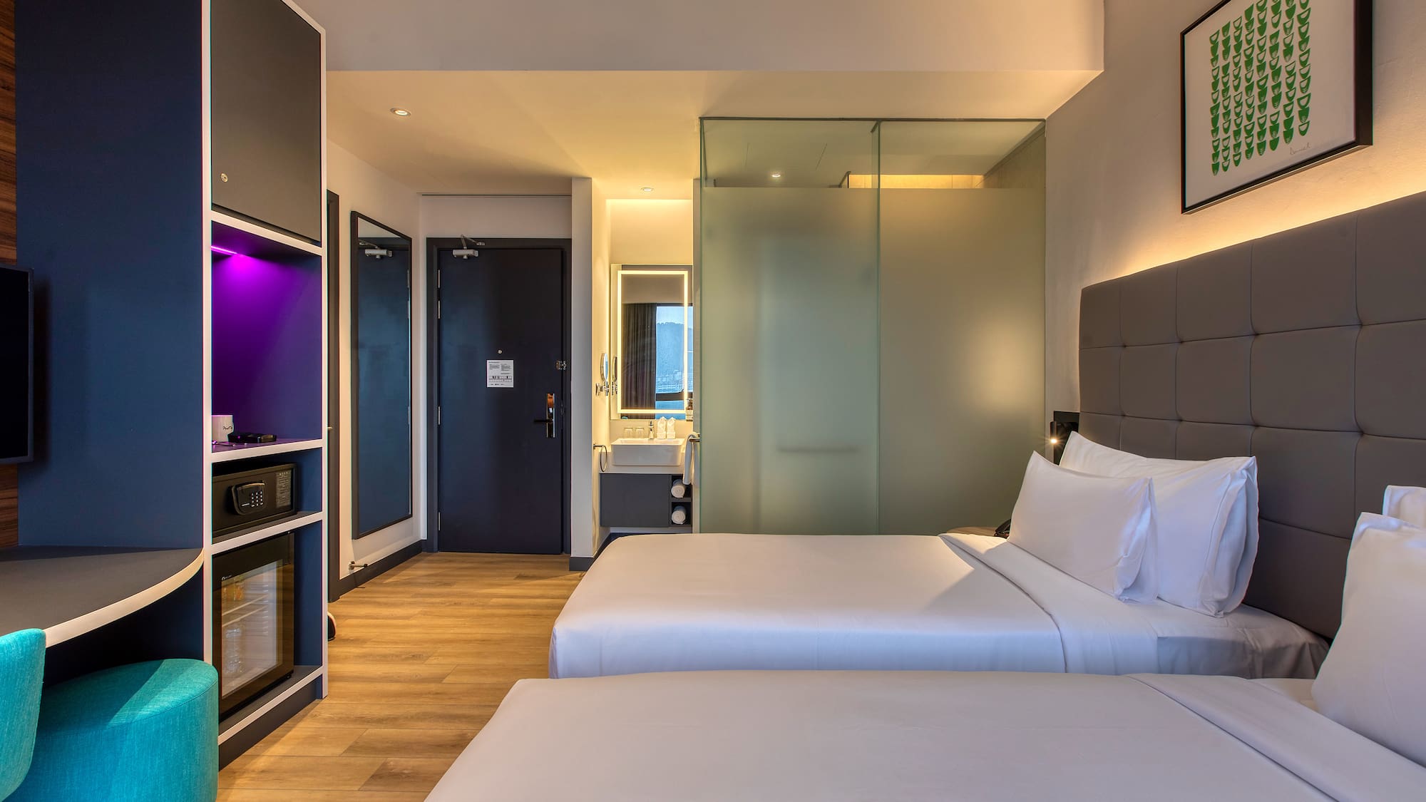 a room with two beds and a glass door