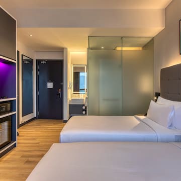 a room with two beds and a glass door
