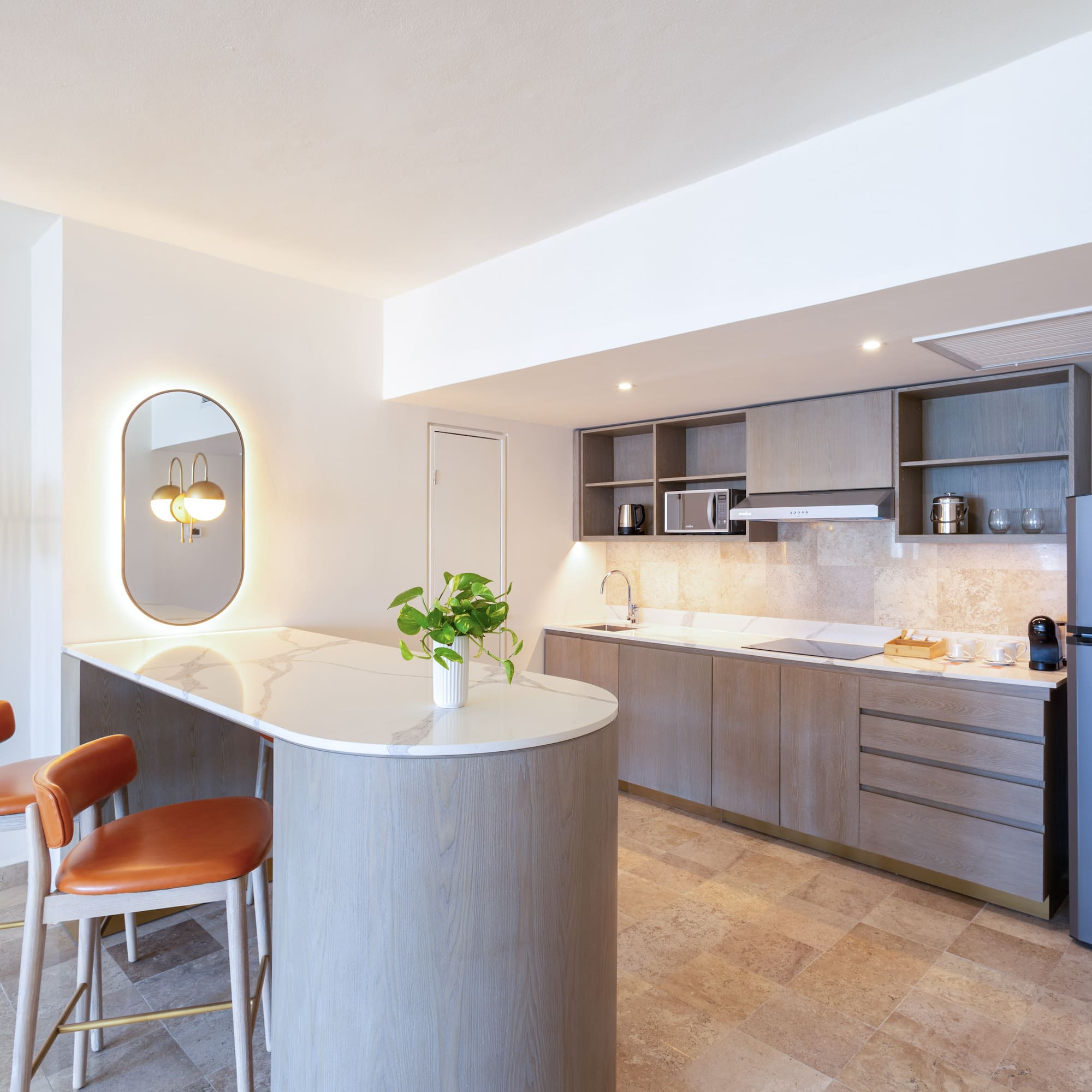 a kitchen with a countertop and chairs