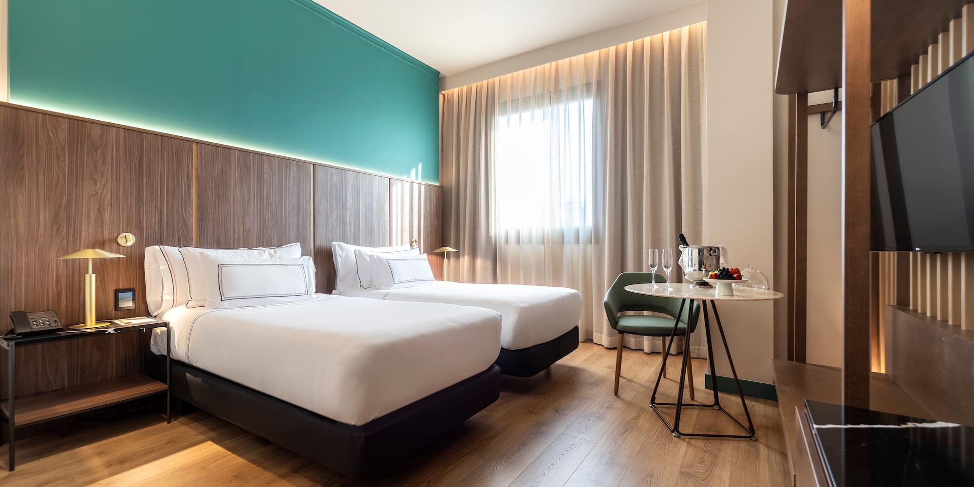 a room with two beds and a table