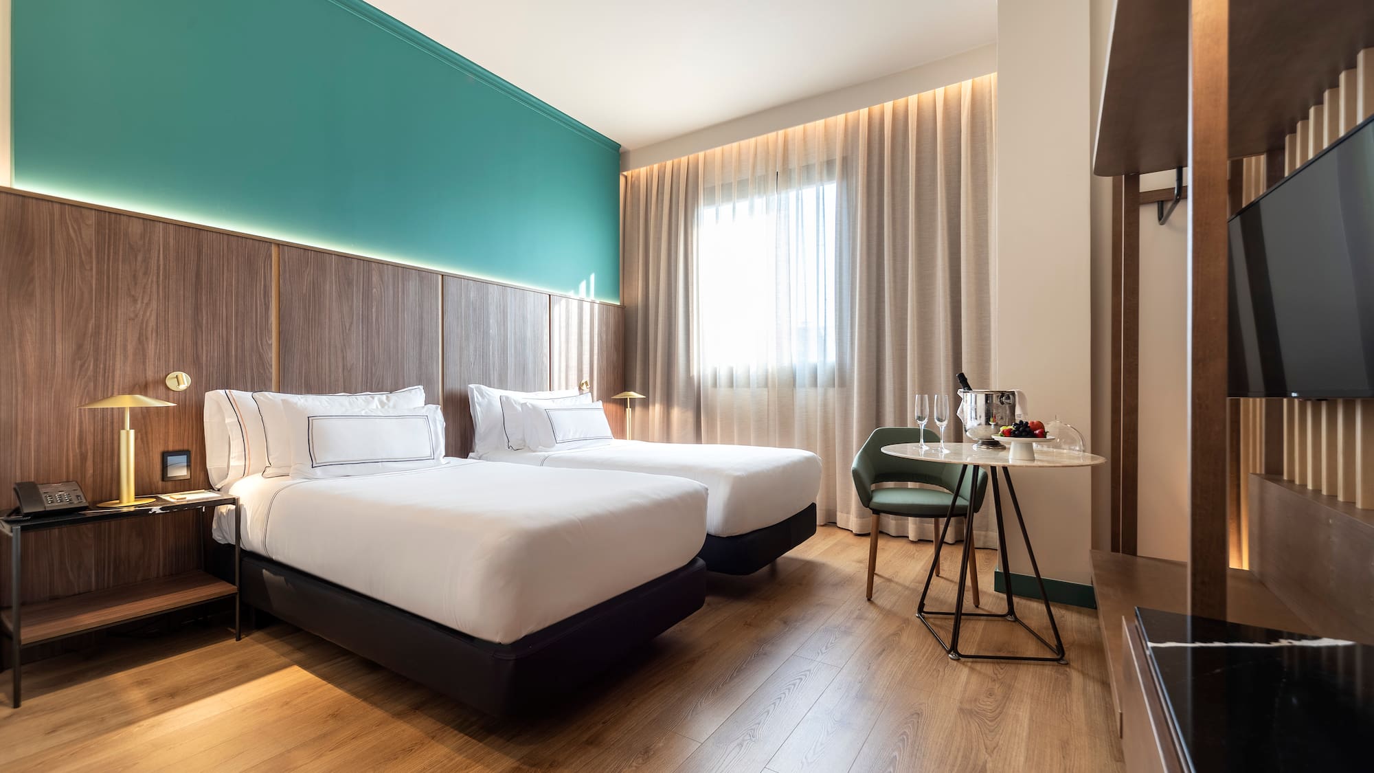 a room with two beds and a table