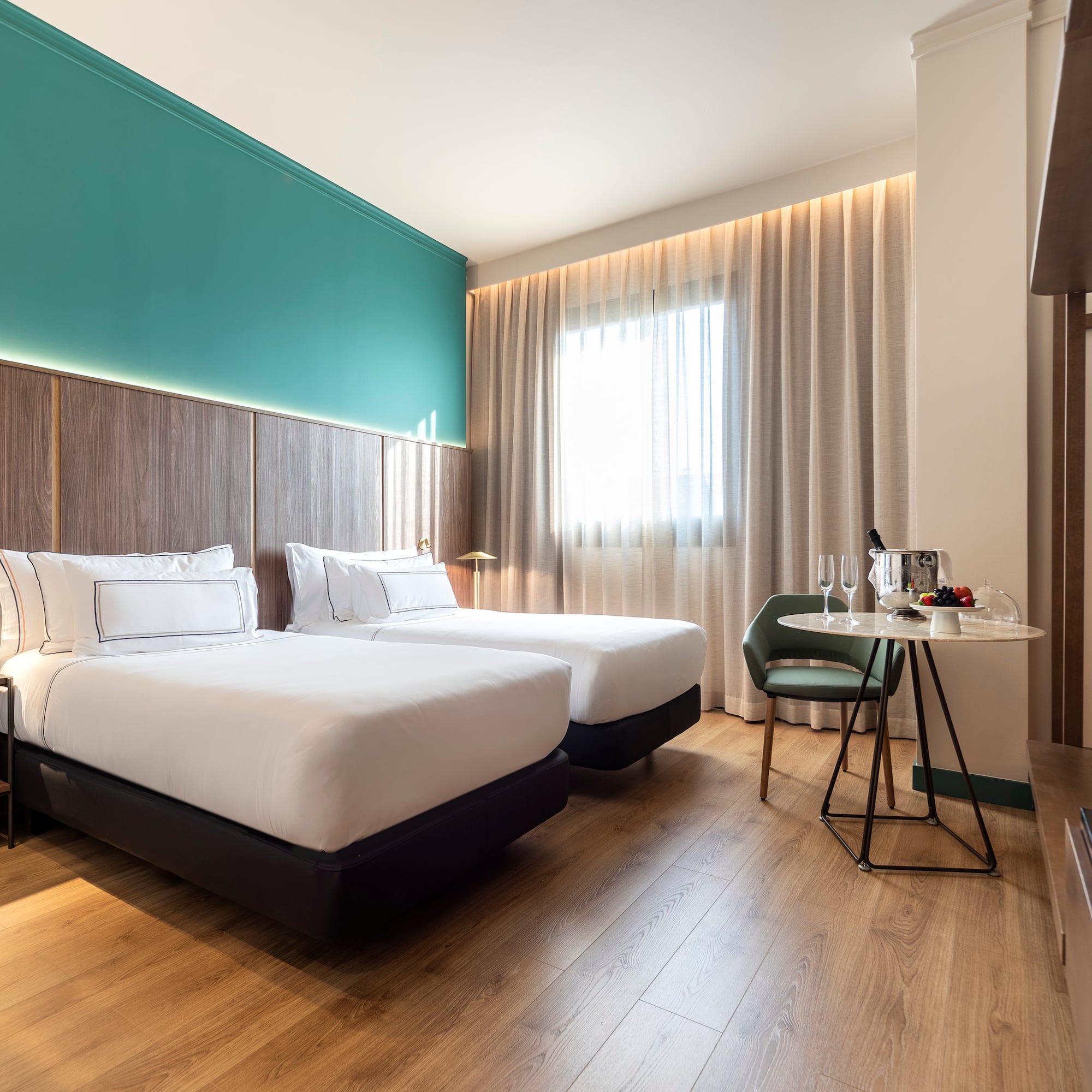 a room with two beds and a table