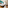 Contemporary hotel room with twin beds, teal wall, wood, and amenities.