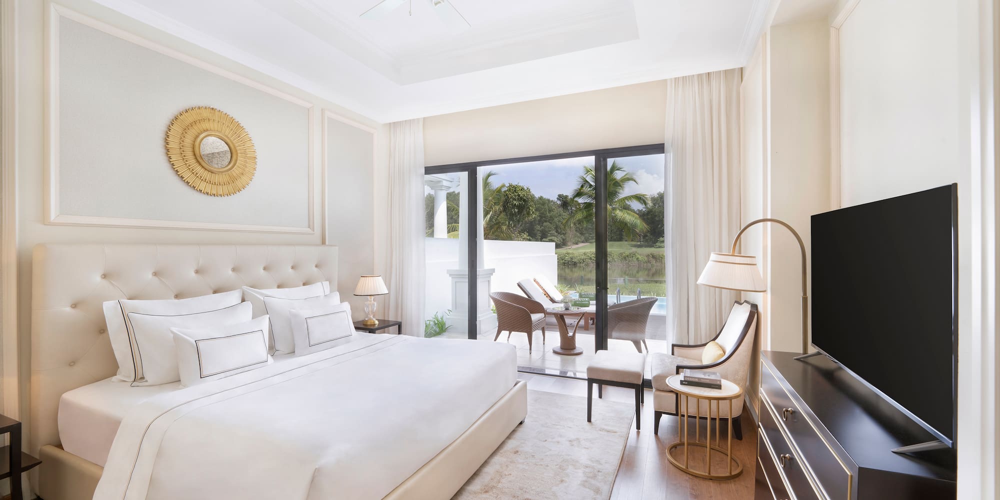 a bedroom with a television and a large bed