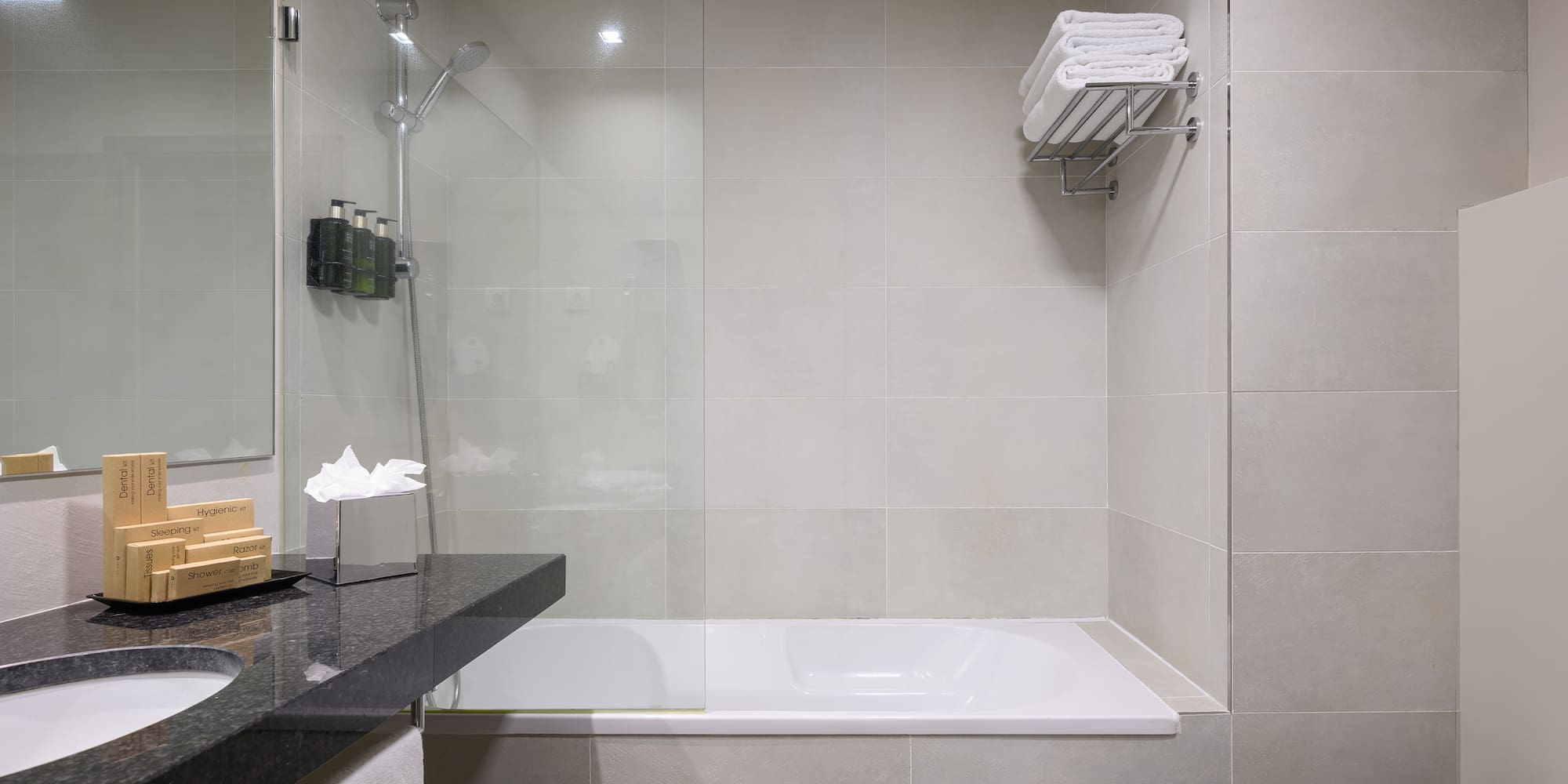 a bathroom with a glass shower and a bathtub