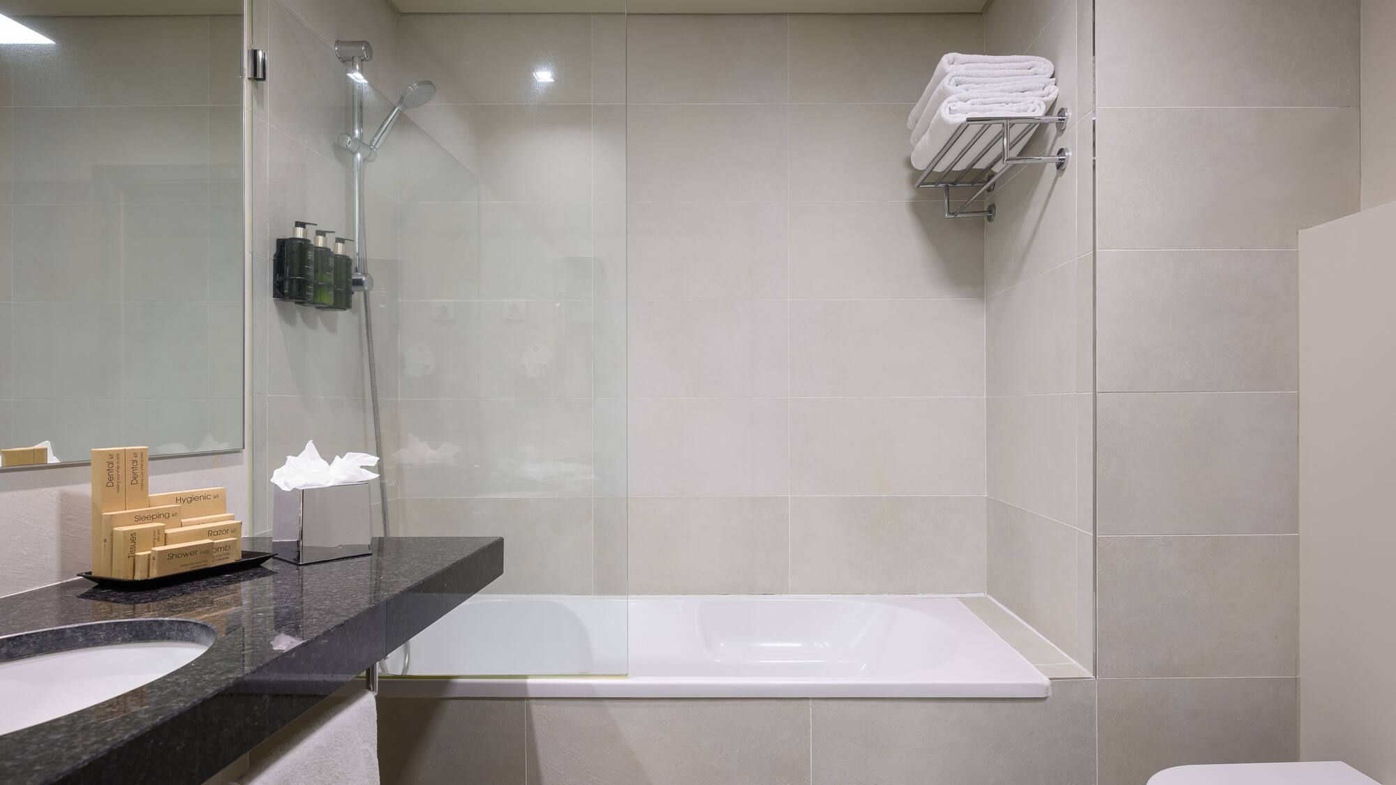 a bathroom with a glass shower and a bathtub