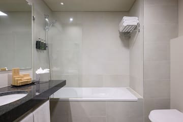 a bathroom with a glass shower and a bathtub