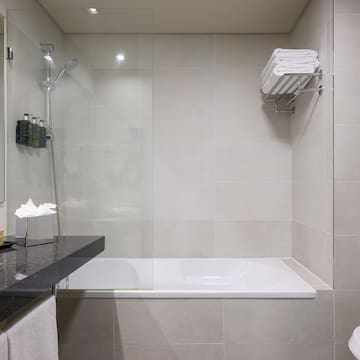 a bathroom with a glass shower and a bathtub