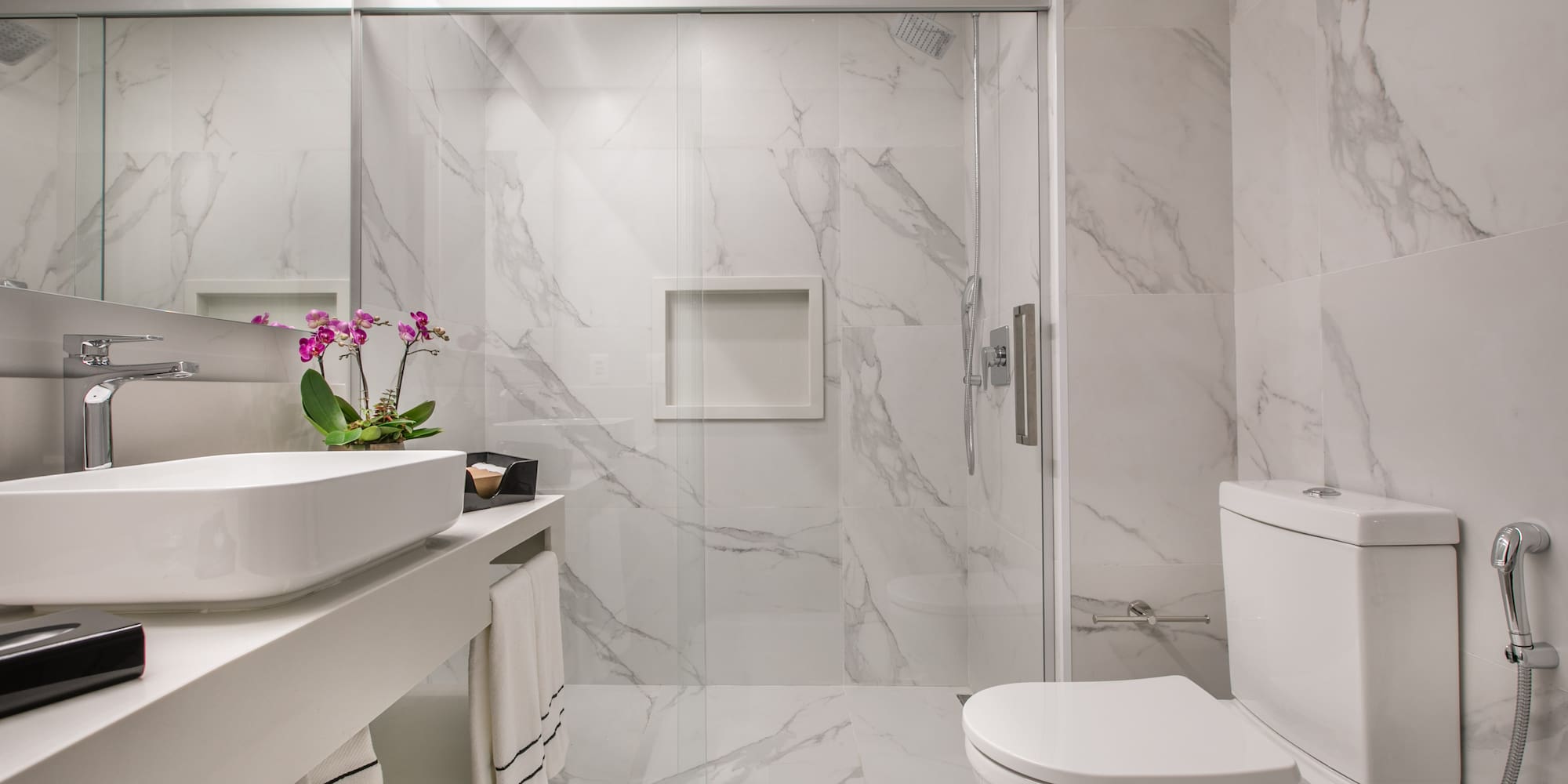 a bathroom with a glass shower door