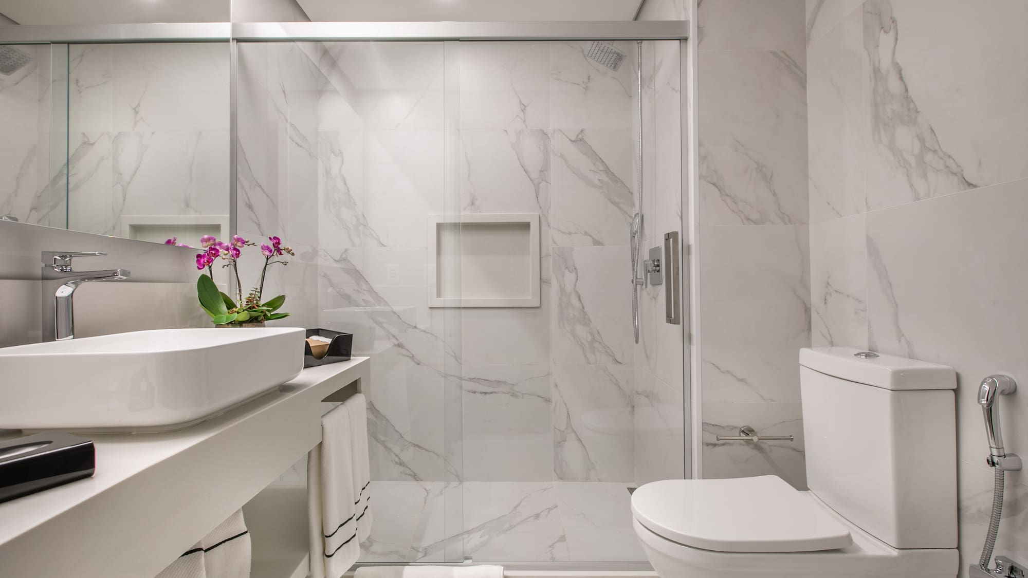 a bathroom with a glass shower door