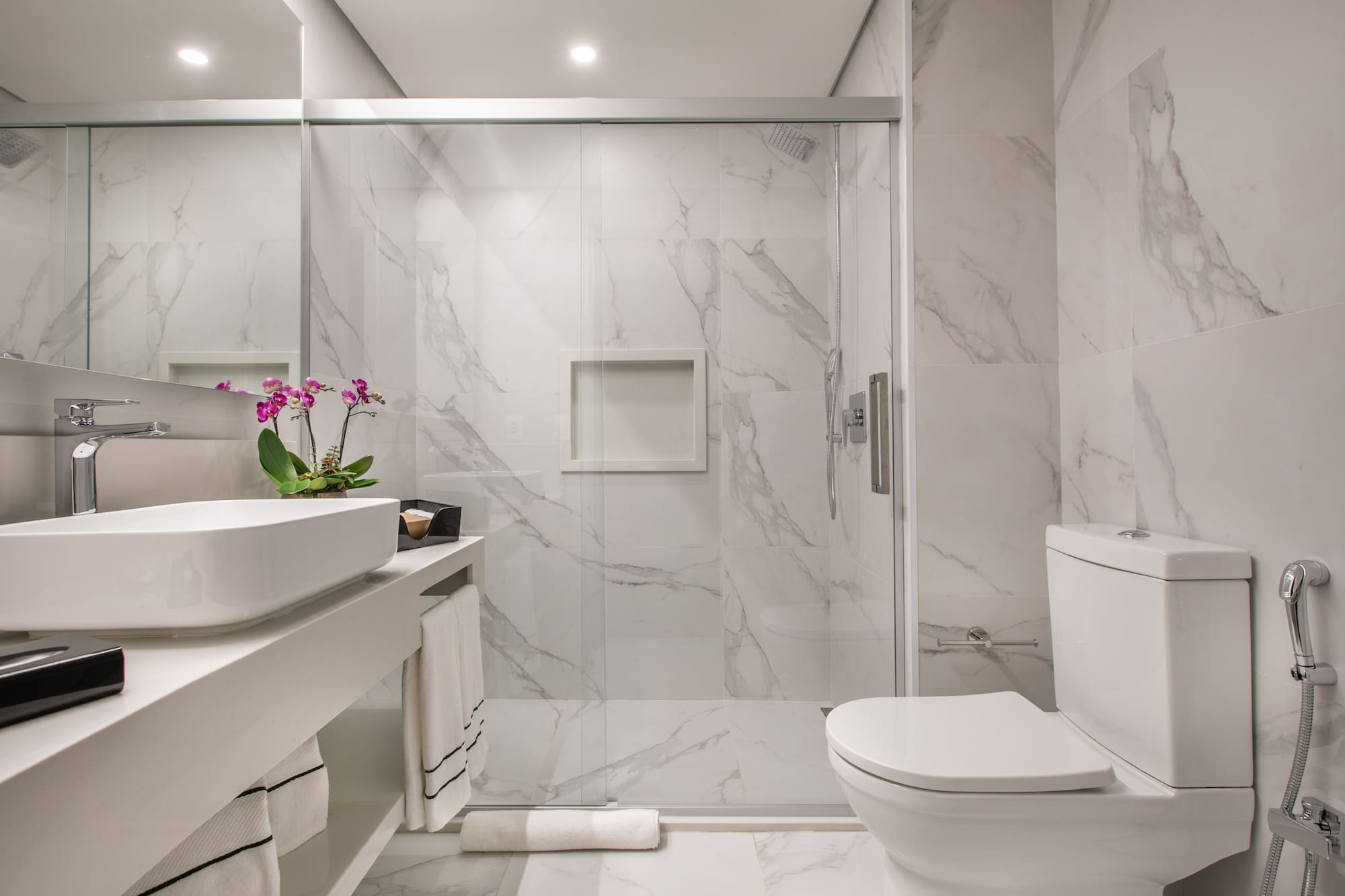 a bathroom with a glass shower door