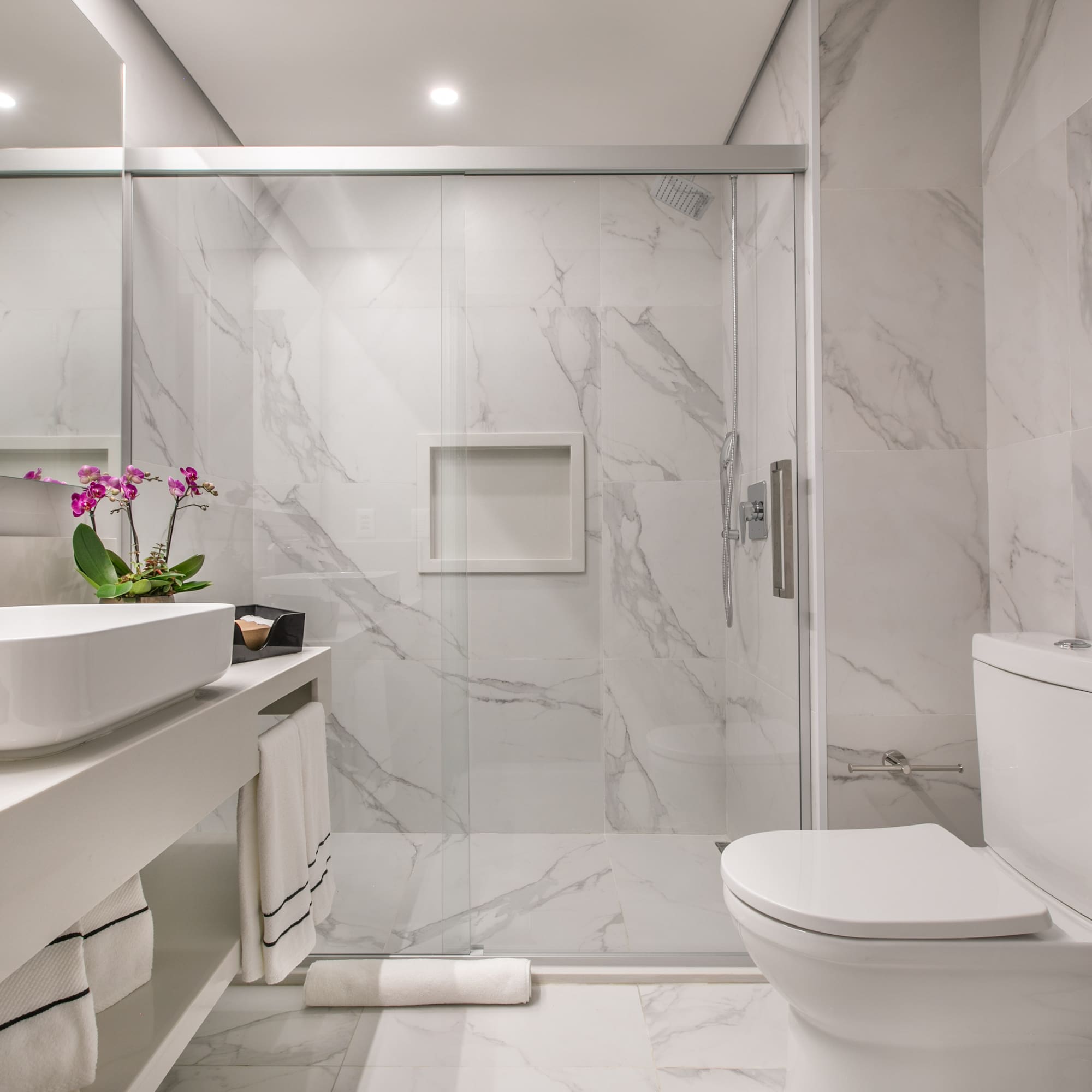 a bathroom with a glass shower door