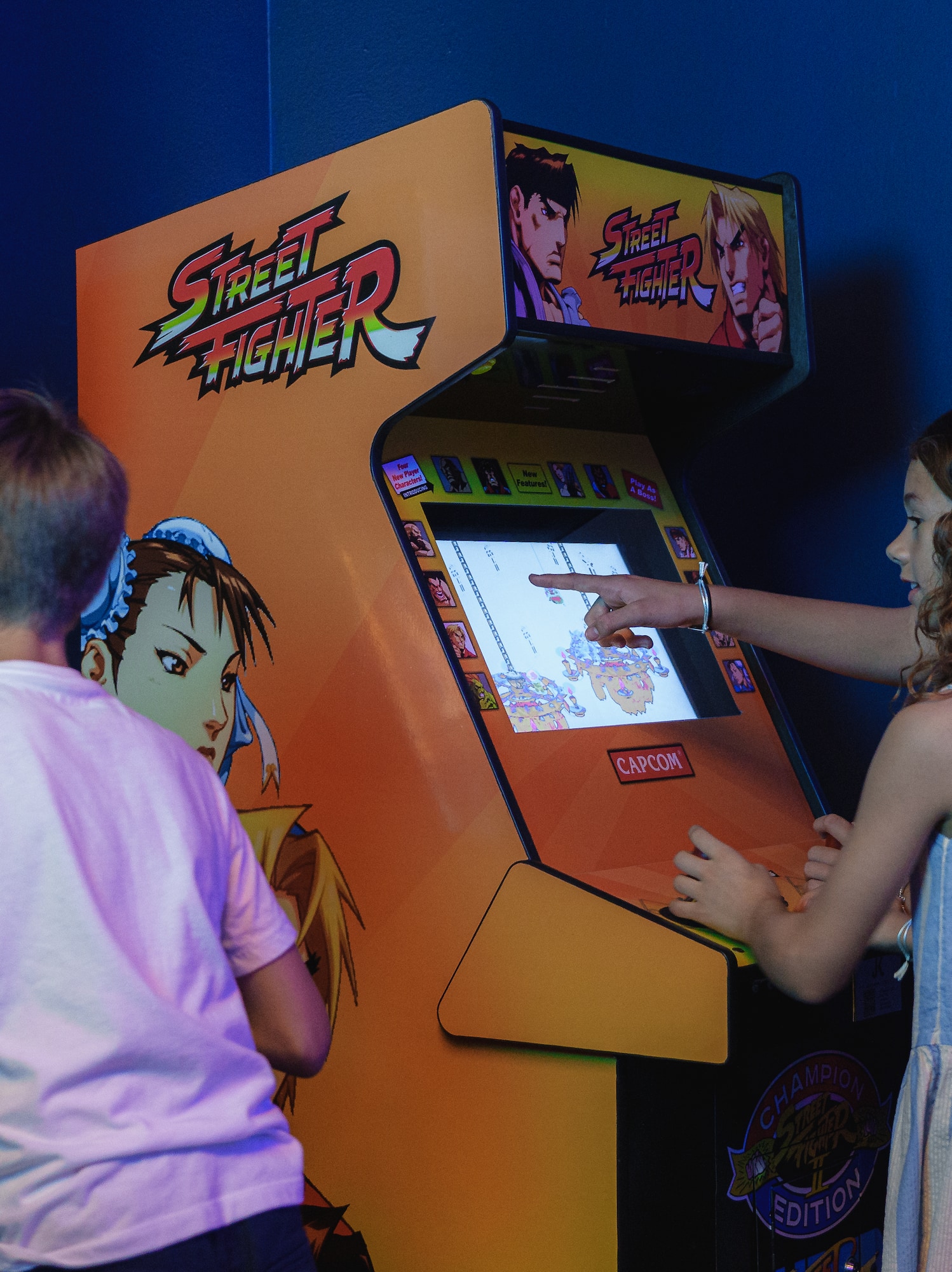 a group of kids playing arcade games