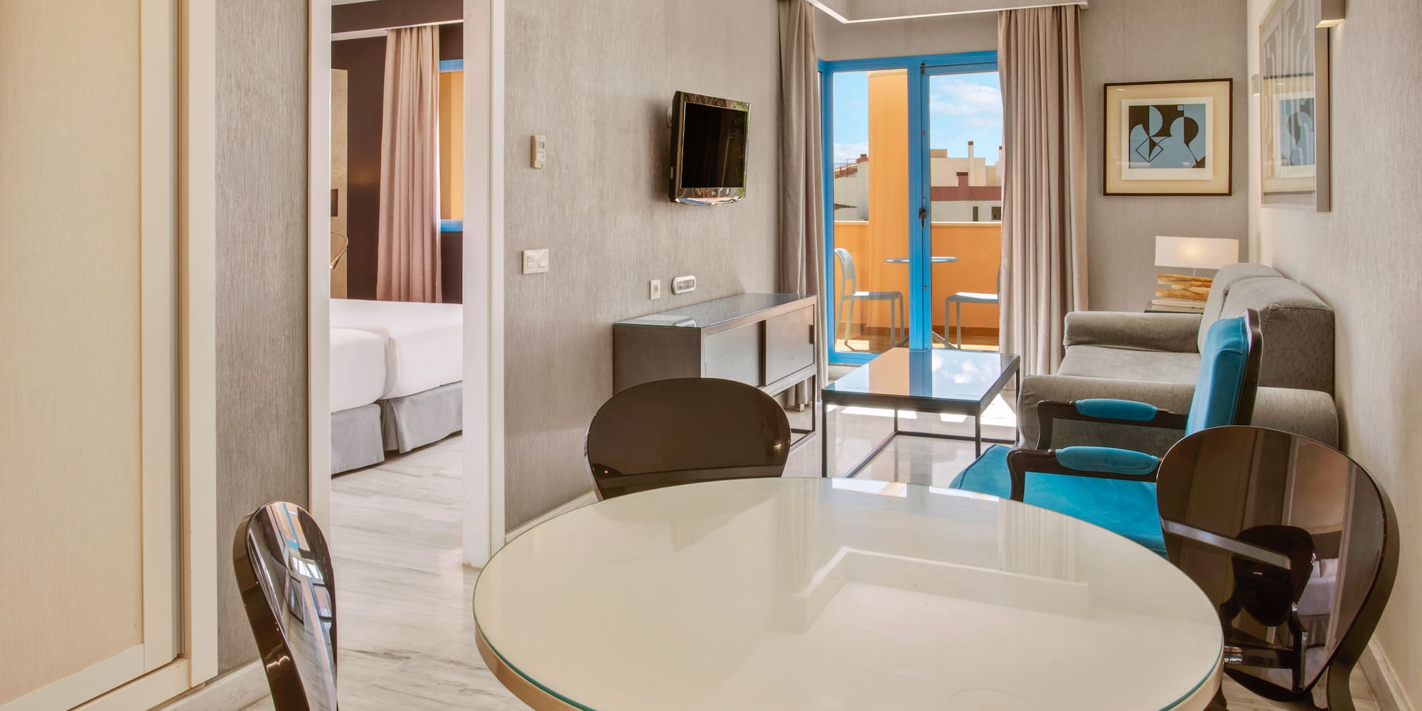 Modern hotel apartment living room, dining table, sofa, and balcony.