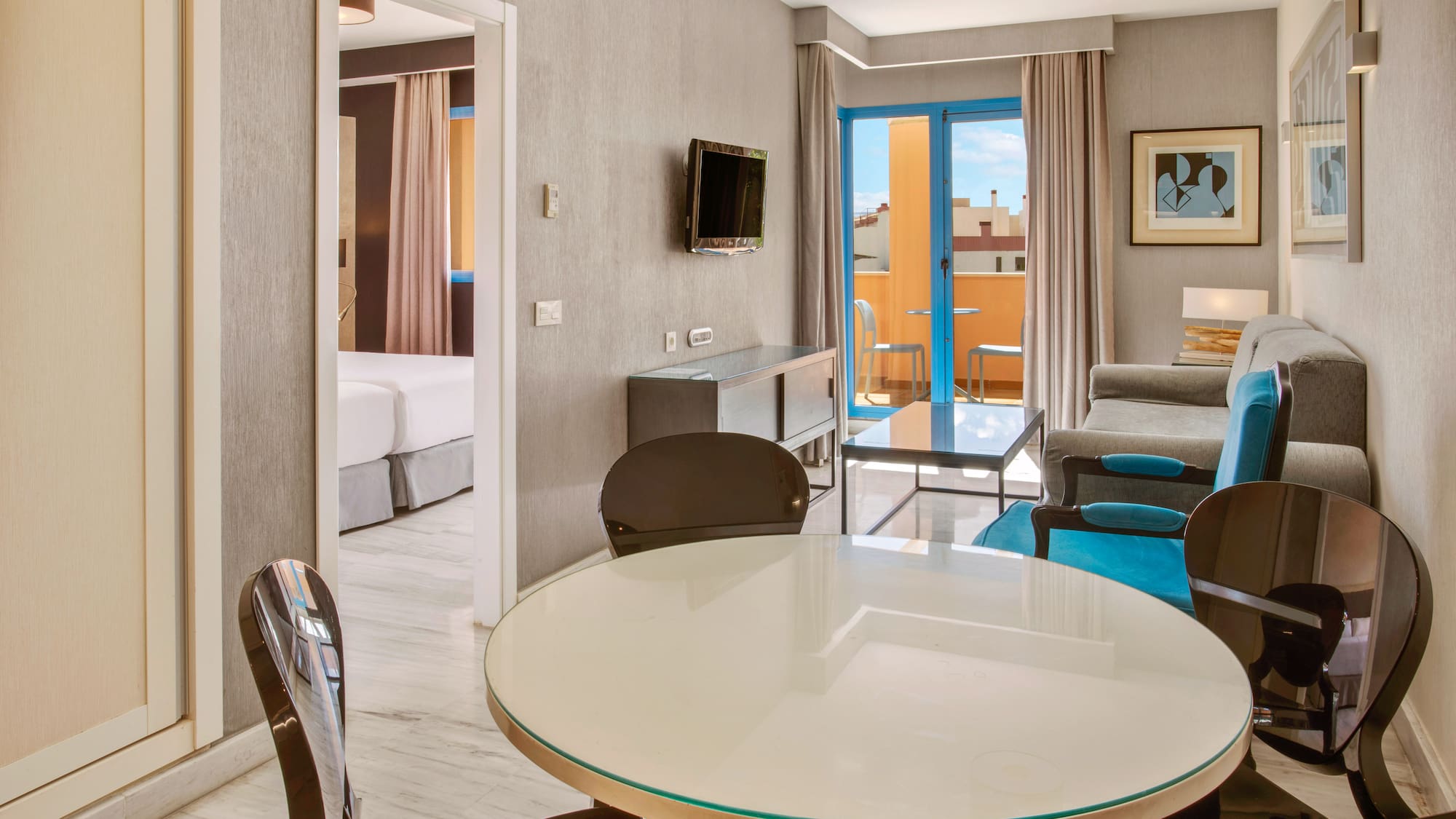 Modern hotel apartment living room, dining table, sofa, and balcony.