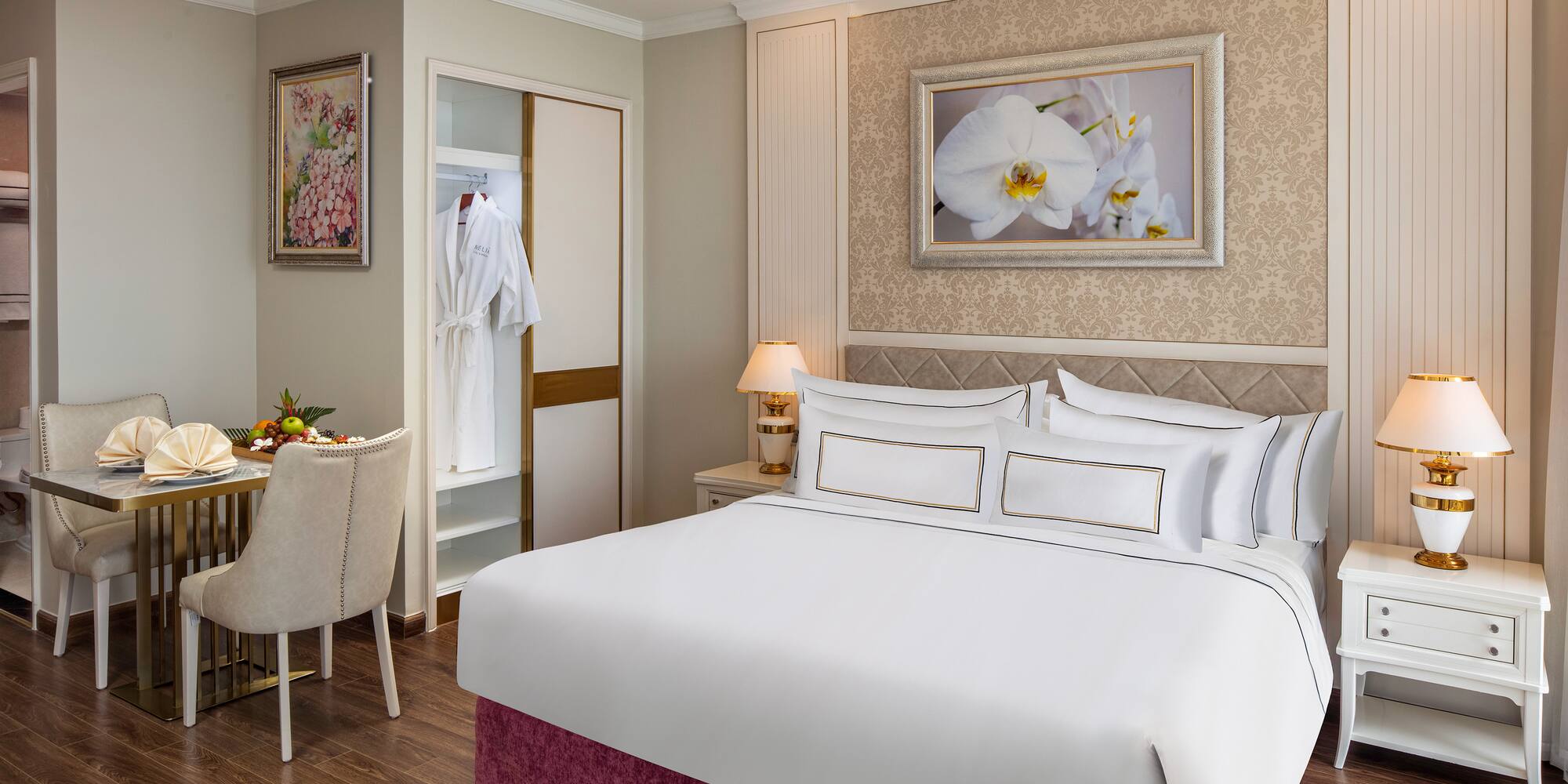 a room with a bed and a table and chairs