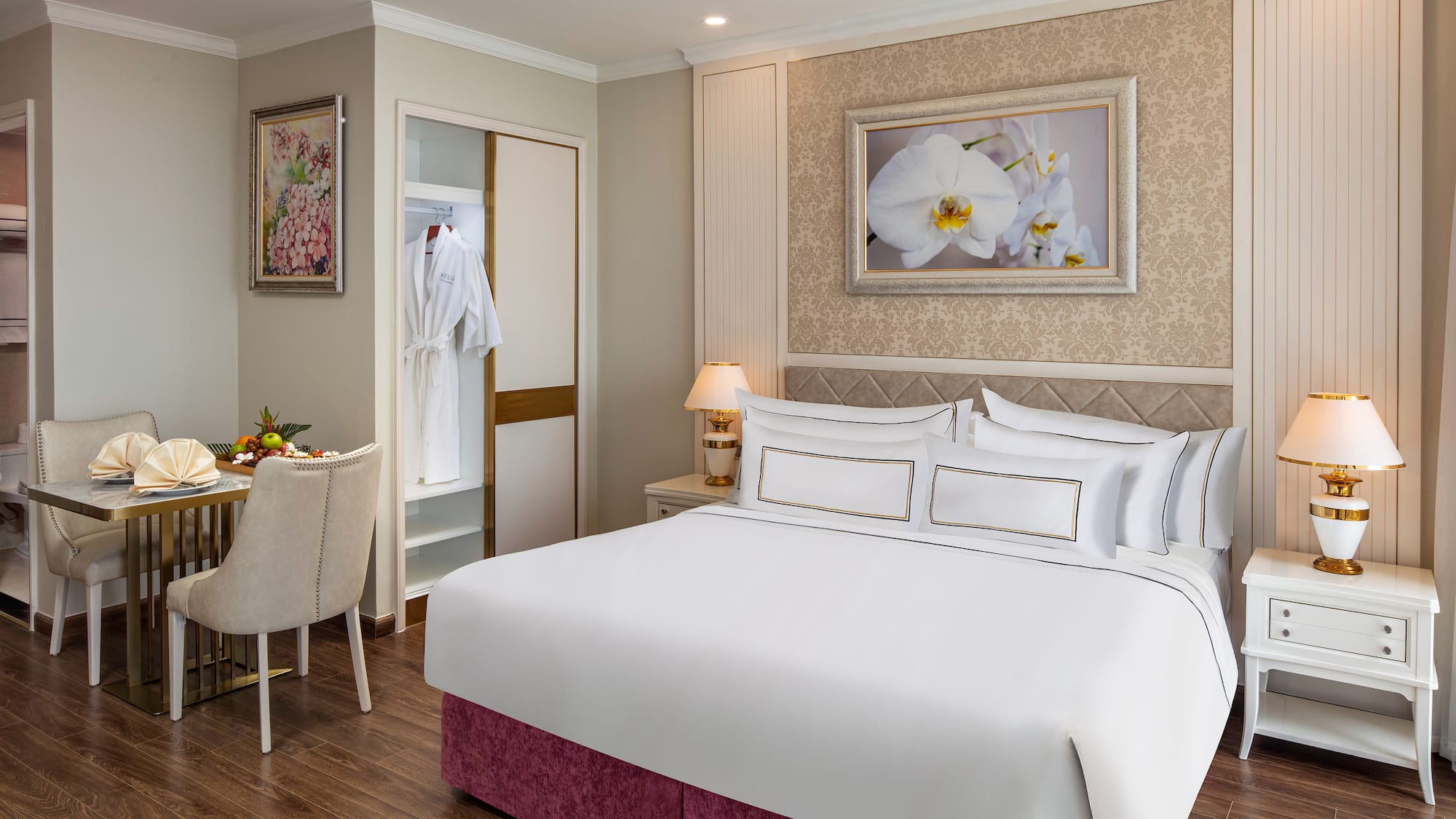 a room with a bed and a table and chairs