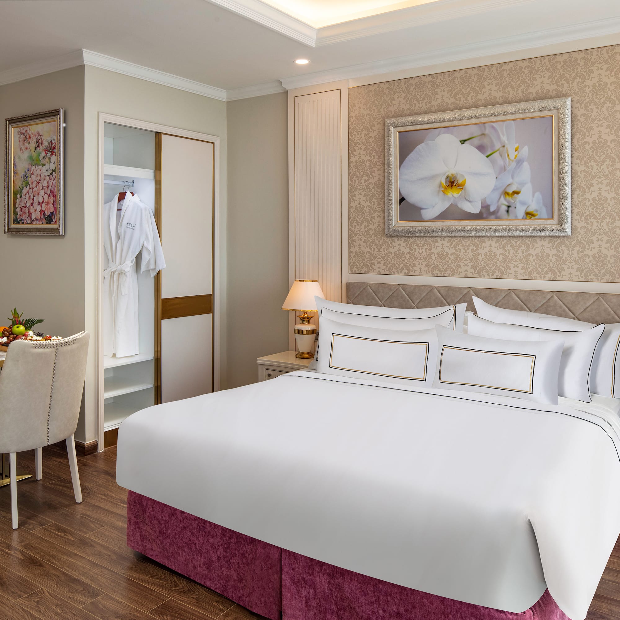 a room with a bed and a table and chairs