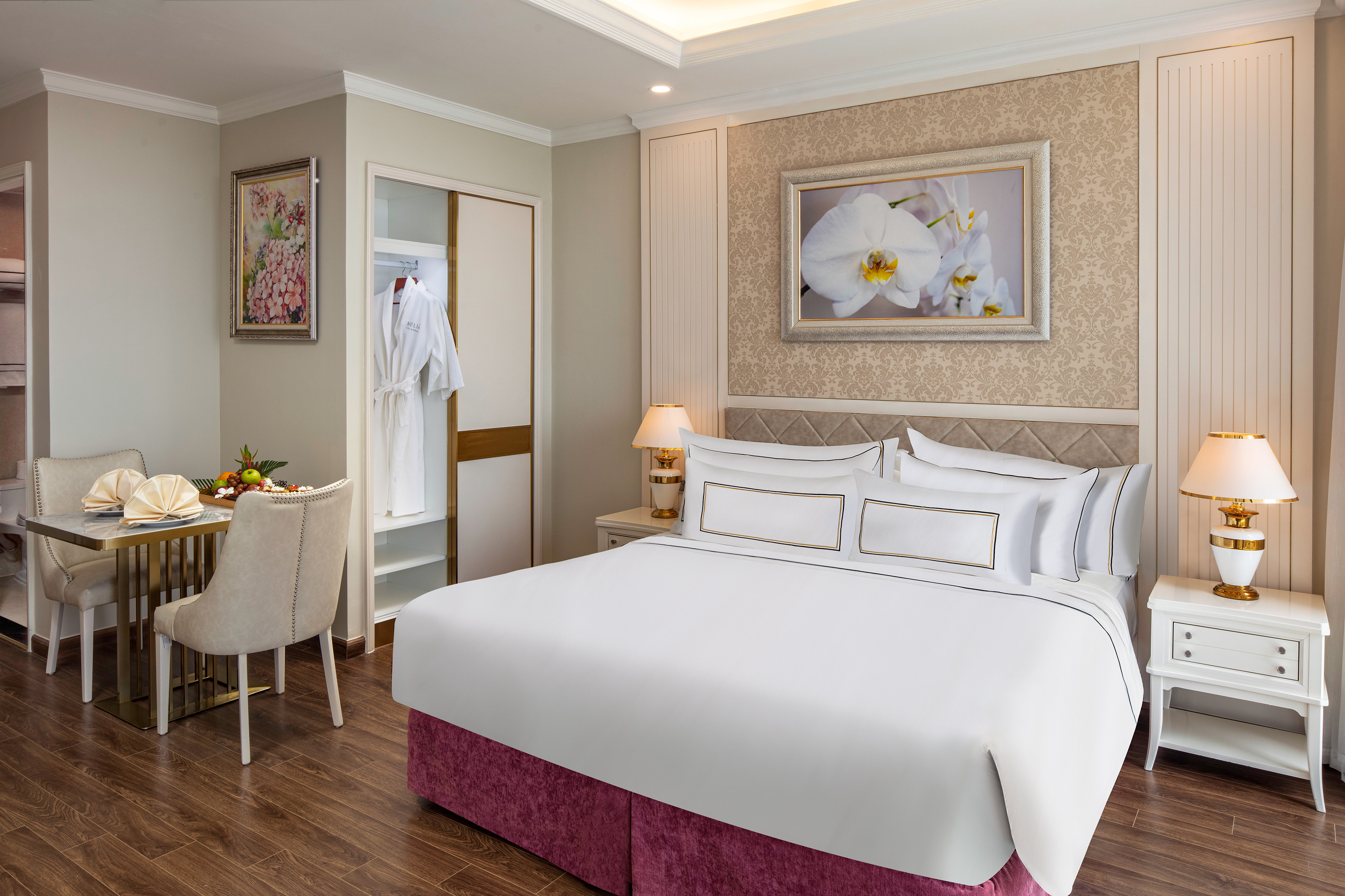 a room with a bed and a table and chairs