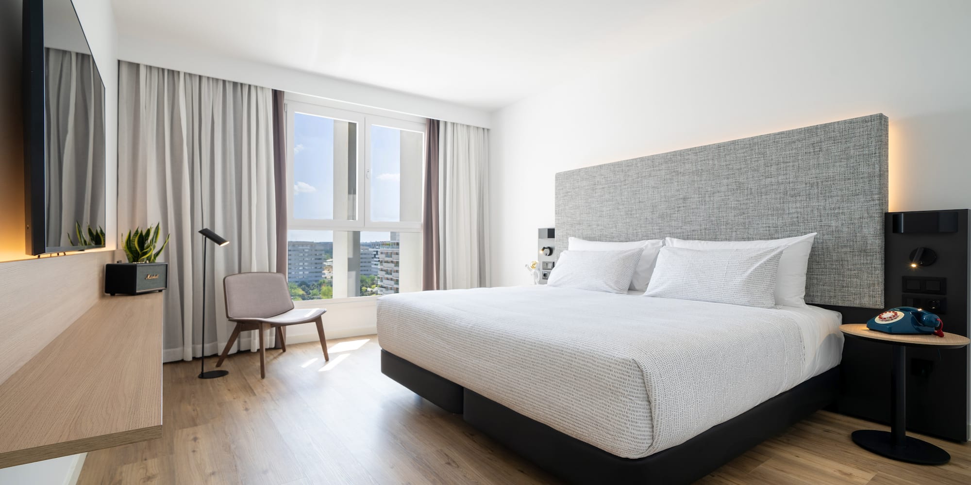 a bedroom with a bed and a chair