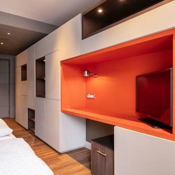 a room with a tv and a bed