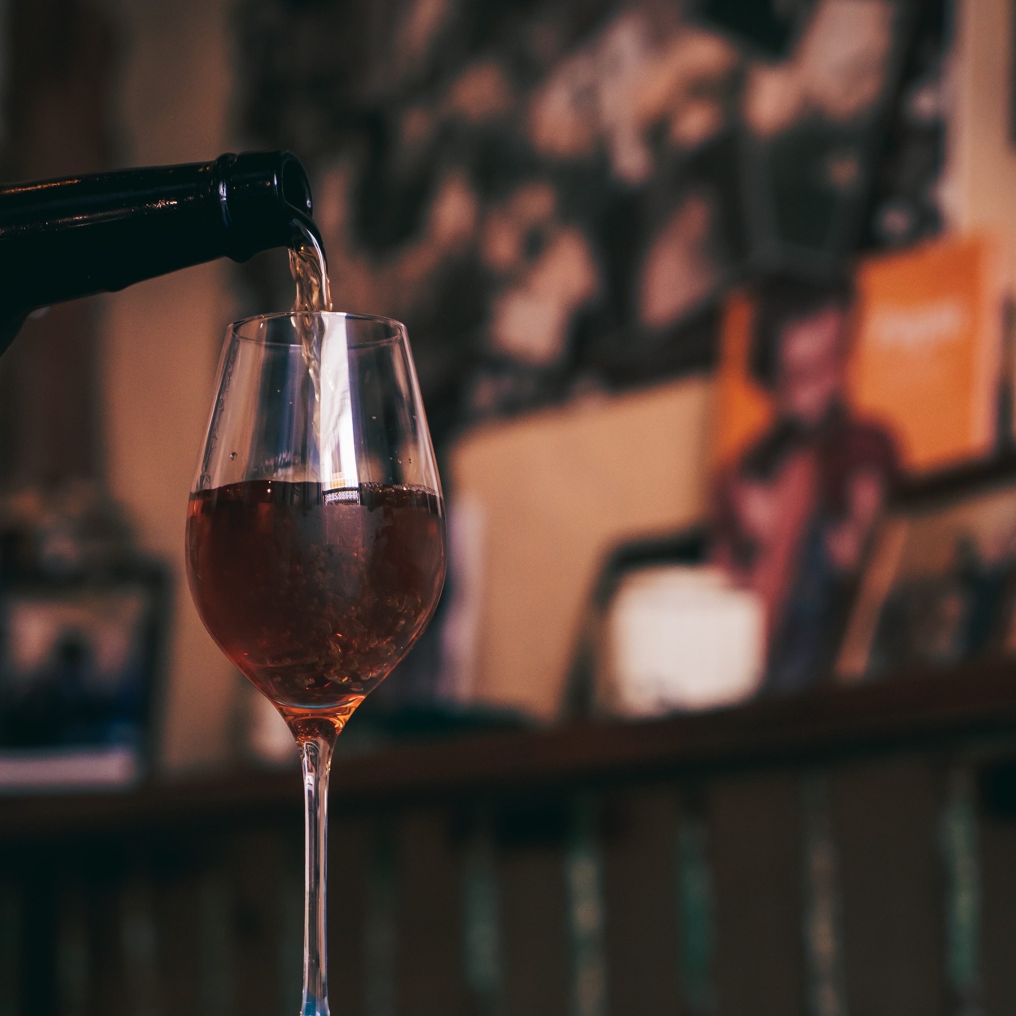 a glass of wine being poured into a glass