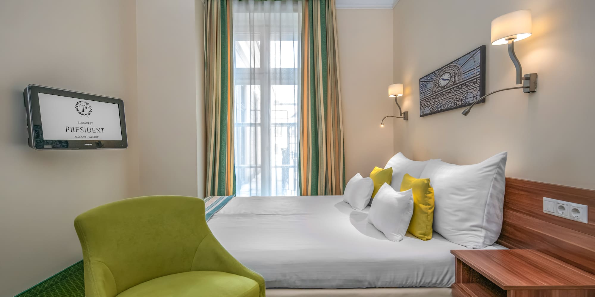 a room with a bed and a green chair