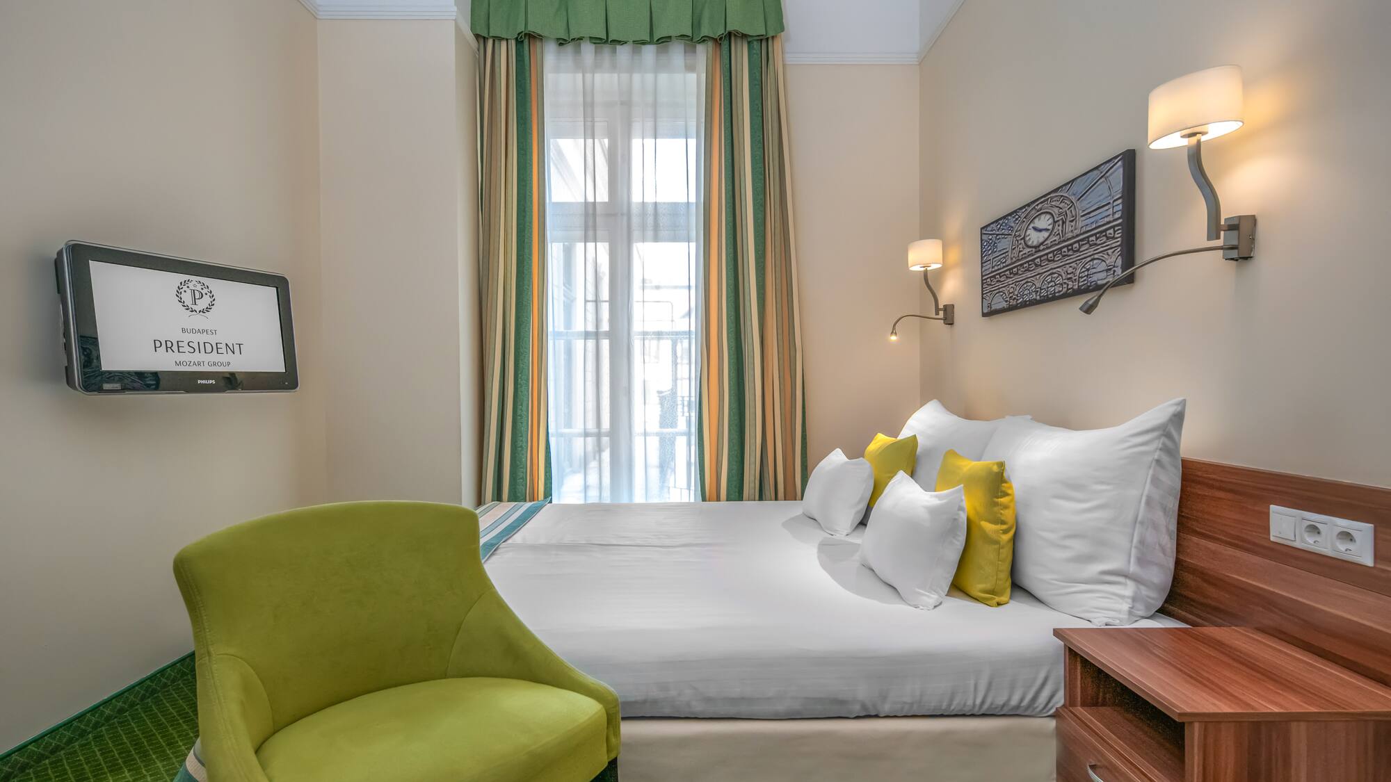 a room with a bed and a green chair