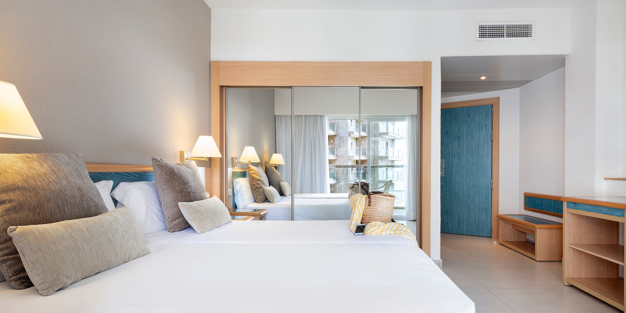 a room with a bed and a mirror