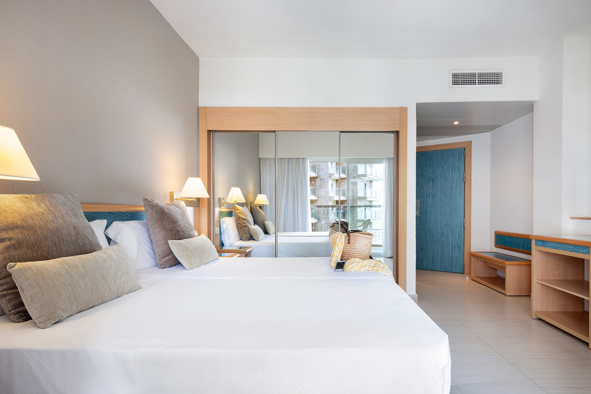 a room with a bed and a mirror