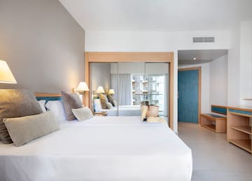 a room with a bed and a mirror