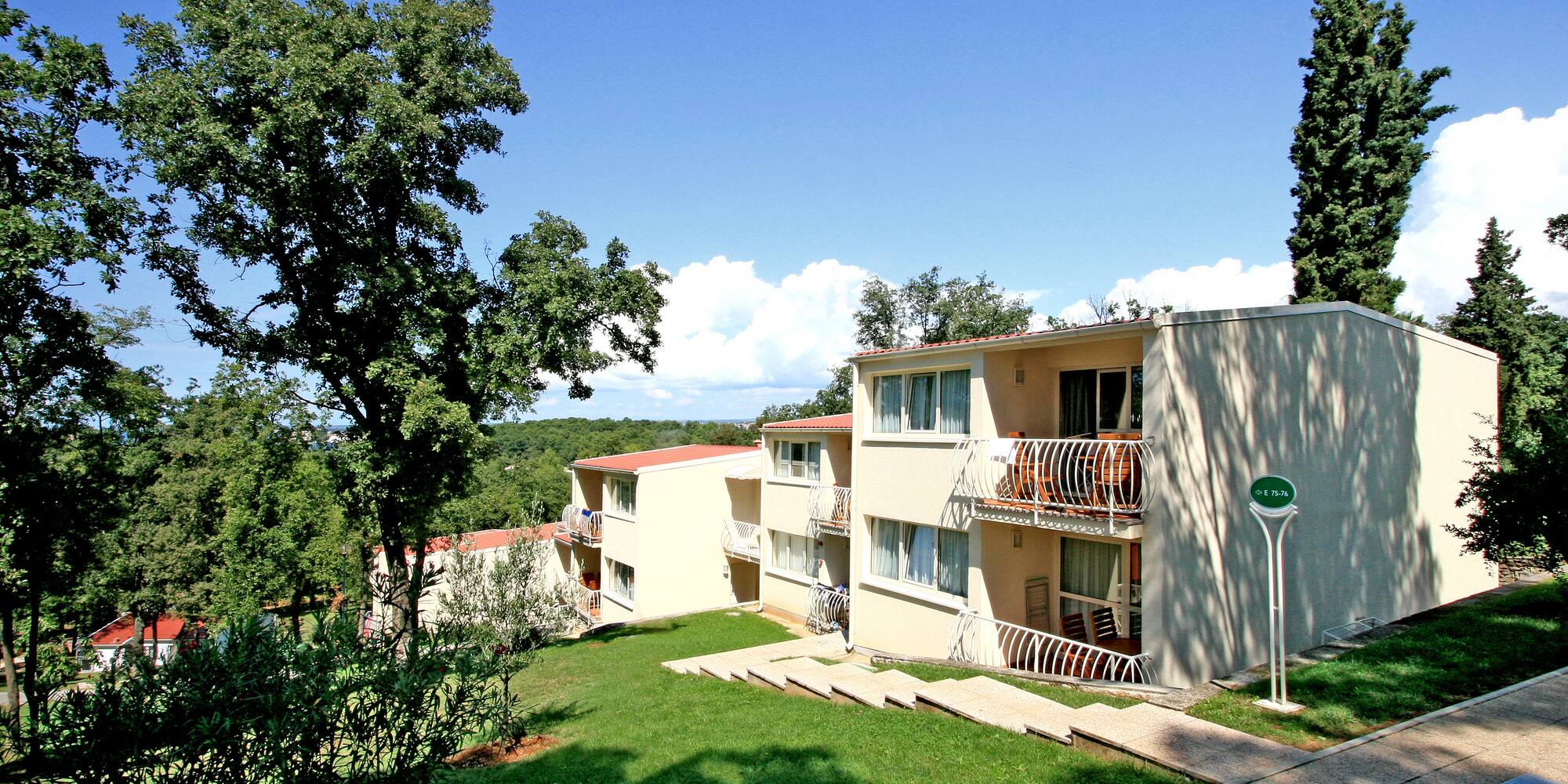 a building with a lawn and trees