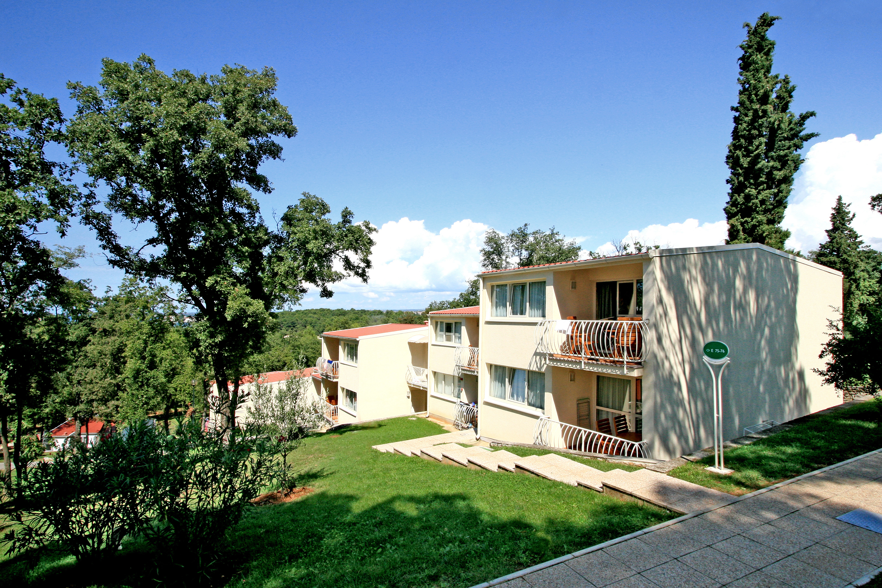 a building with a lawn and trees