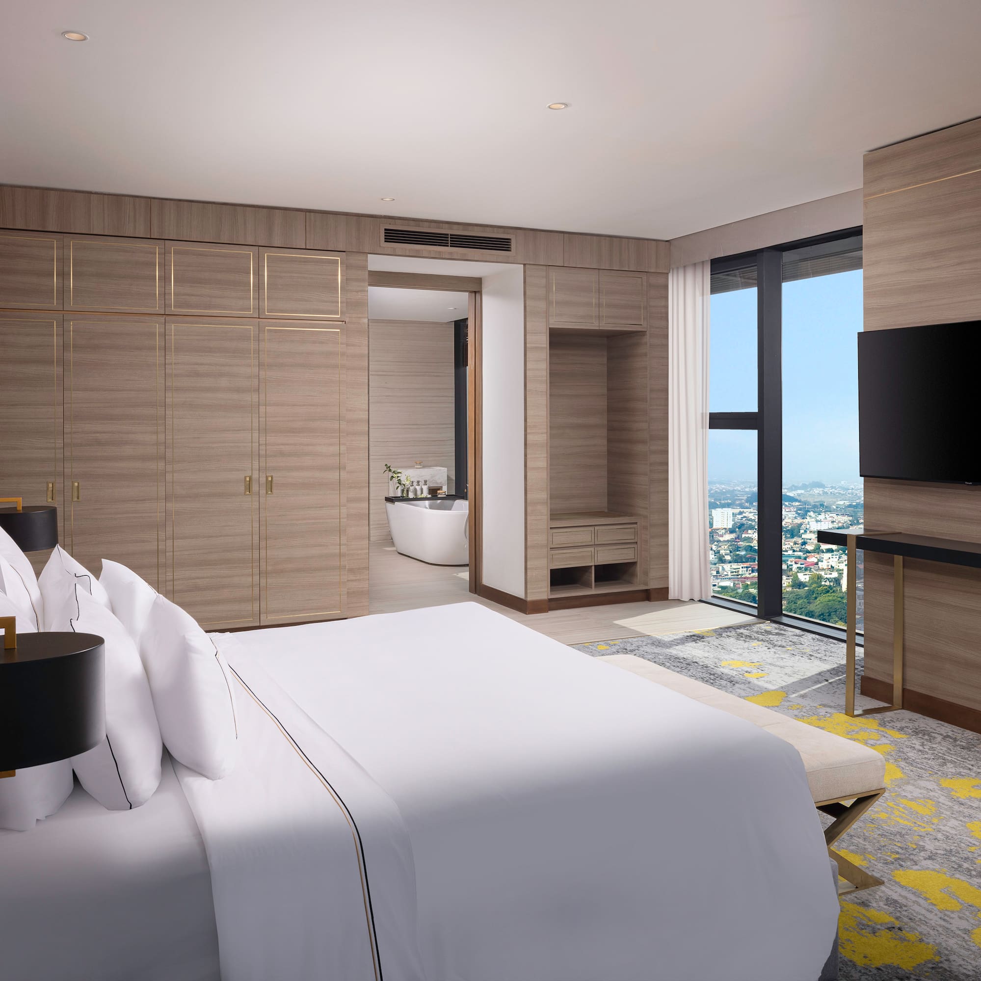 a bedroom with a large window and a large bed