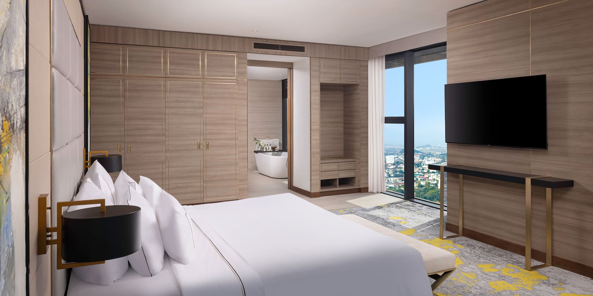 a bedroom with a large window and a large bed