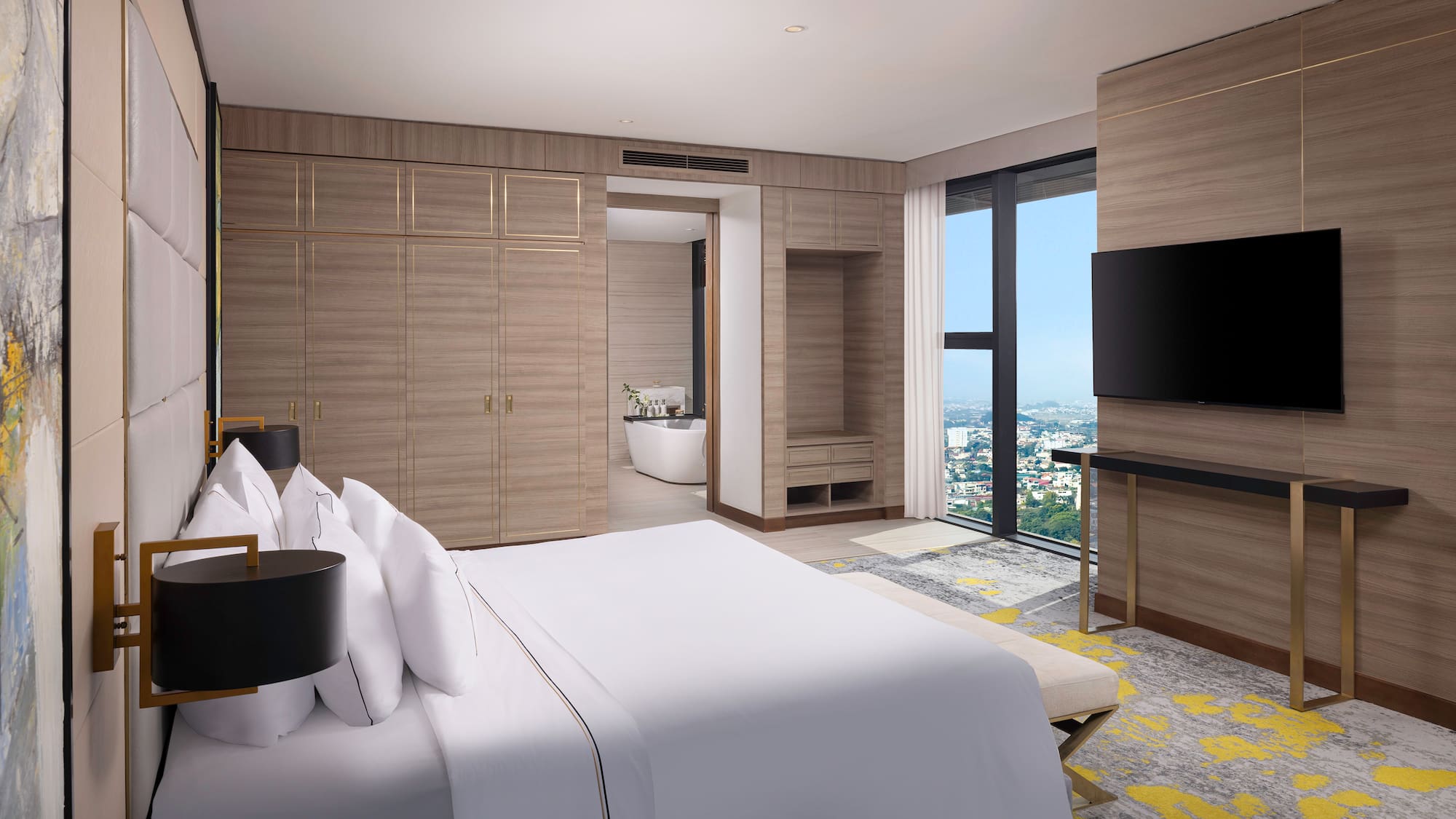 a bedroom with a large window and a large bed