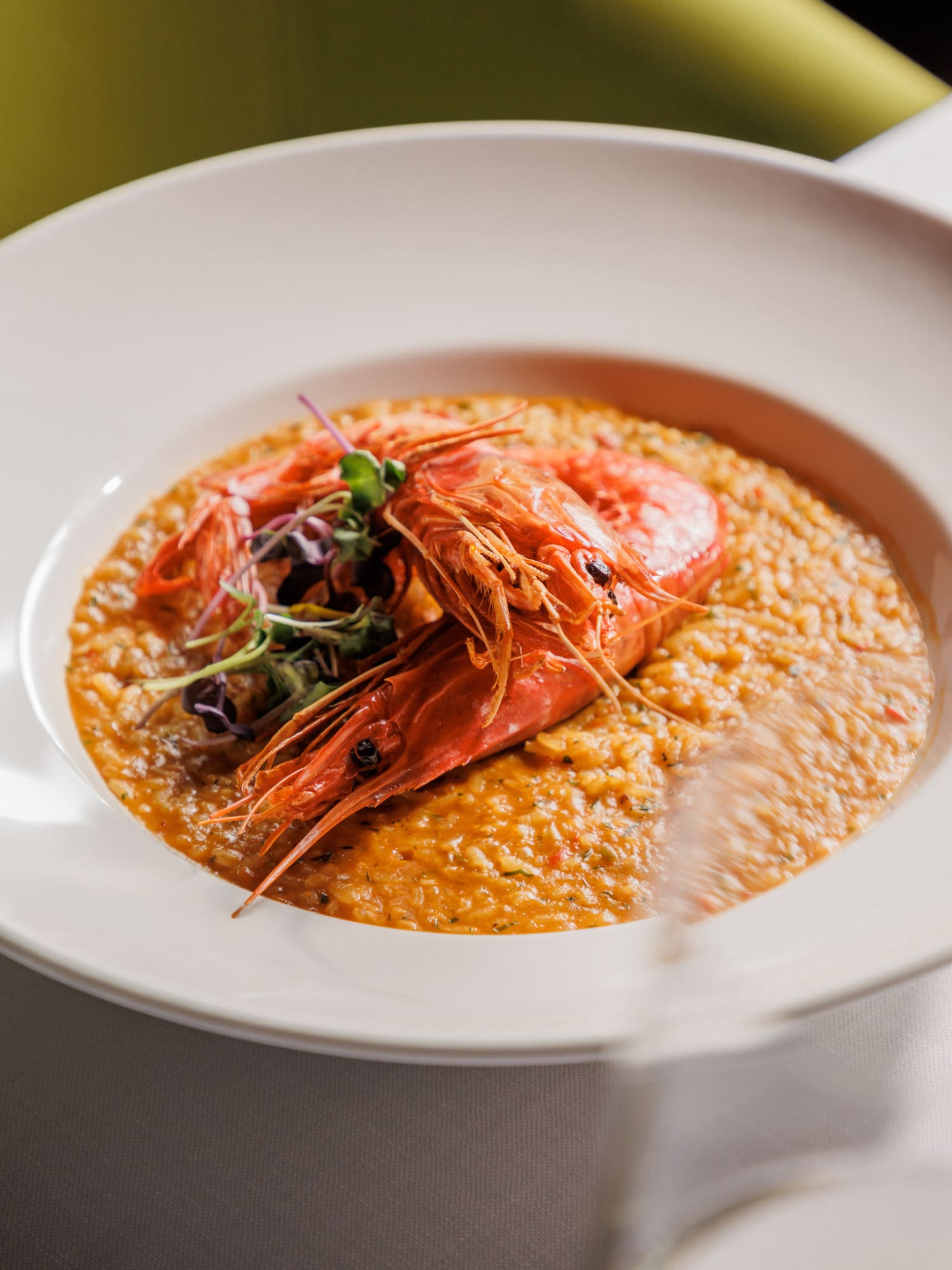 a bowl of food with shrimp and vegetables