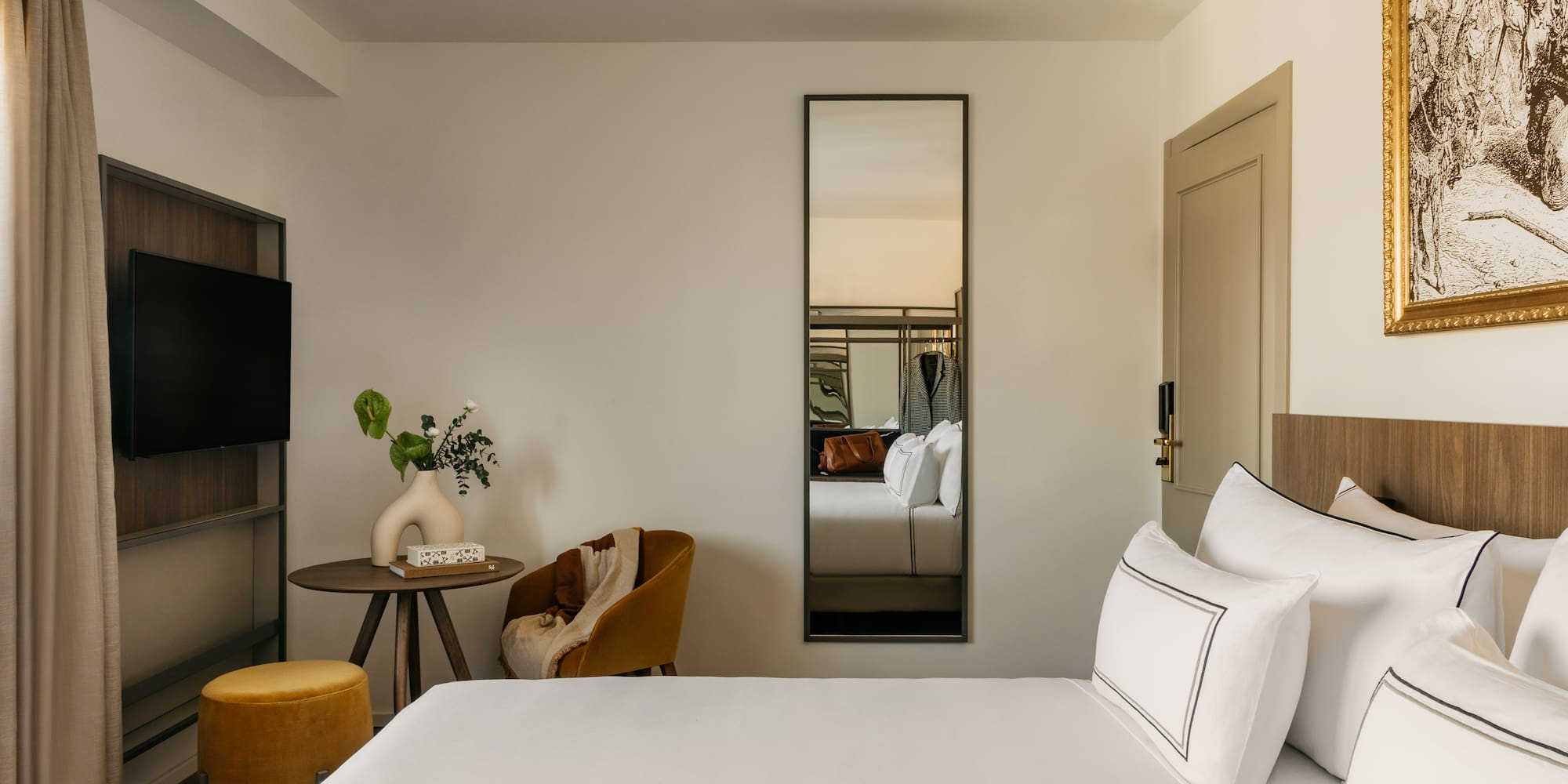 a room with a bed and a mirror