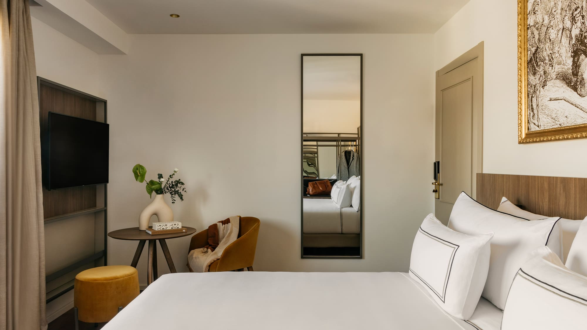 a room with a bed and a mirror