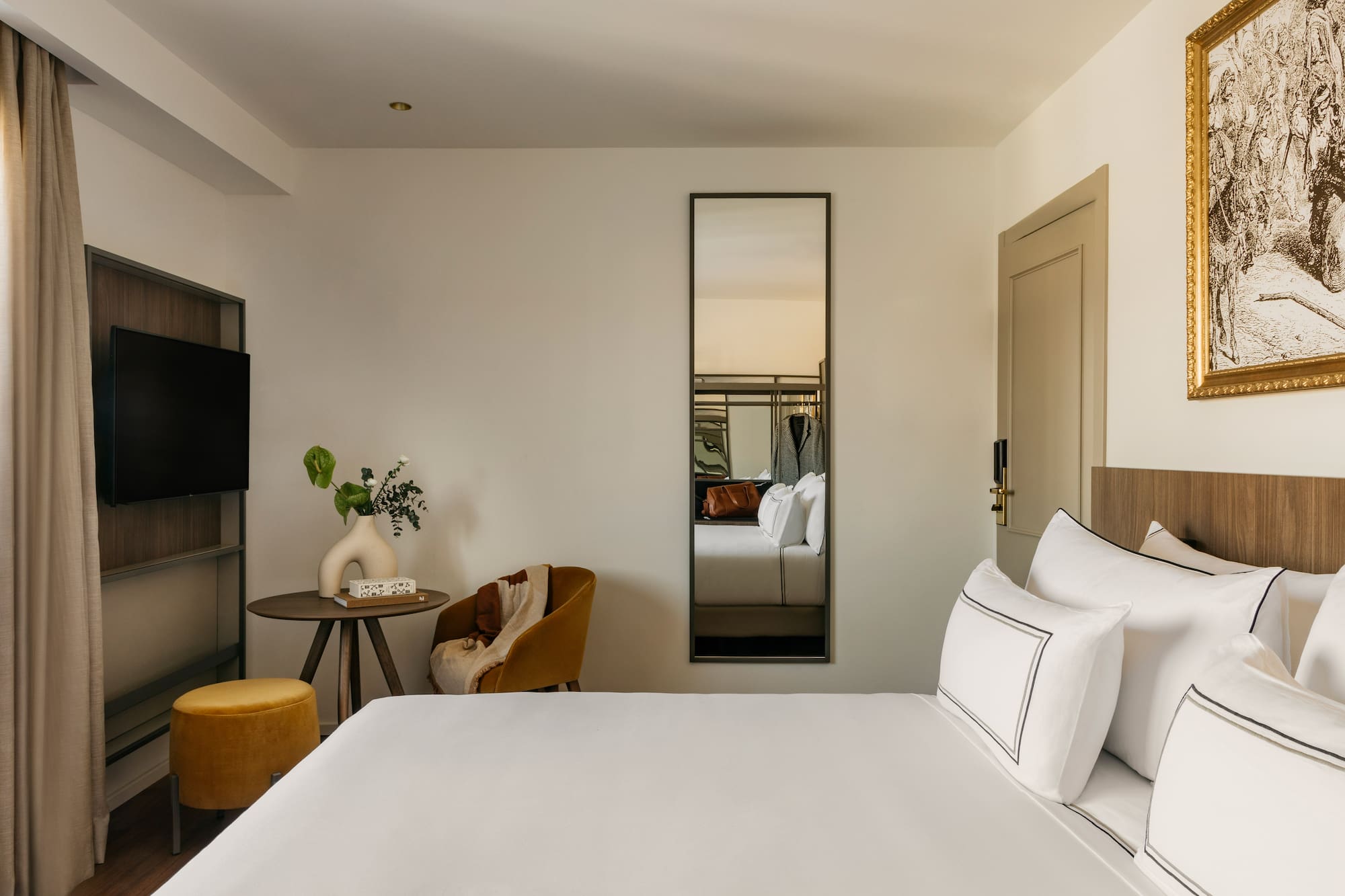 a room with a bed and a mirror