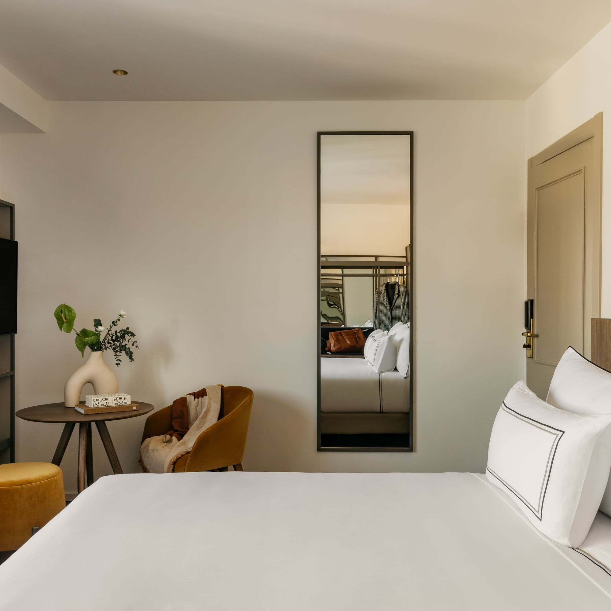 a room with a bed and a mirror