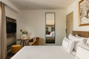 a room with a bed and a mirror