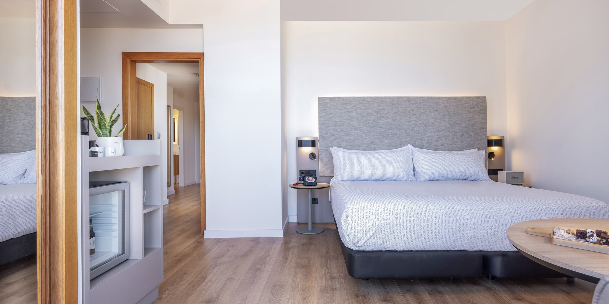 a bedroom with a bed and a wood floor