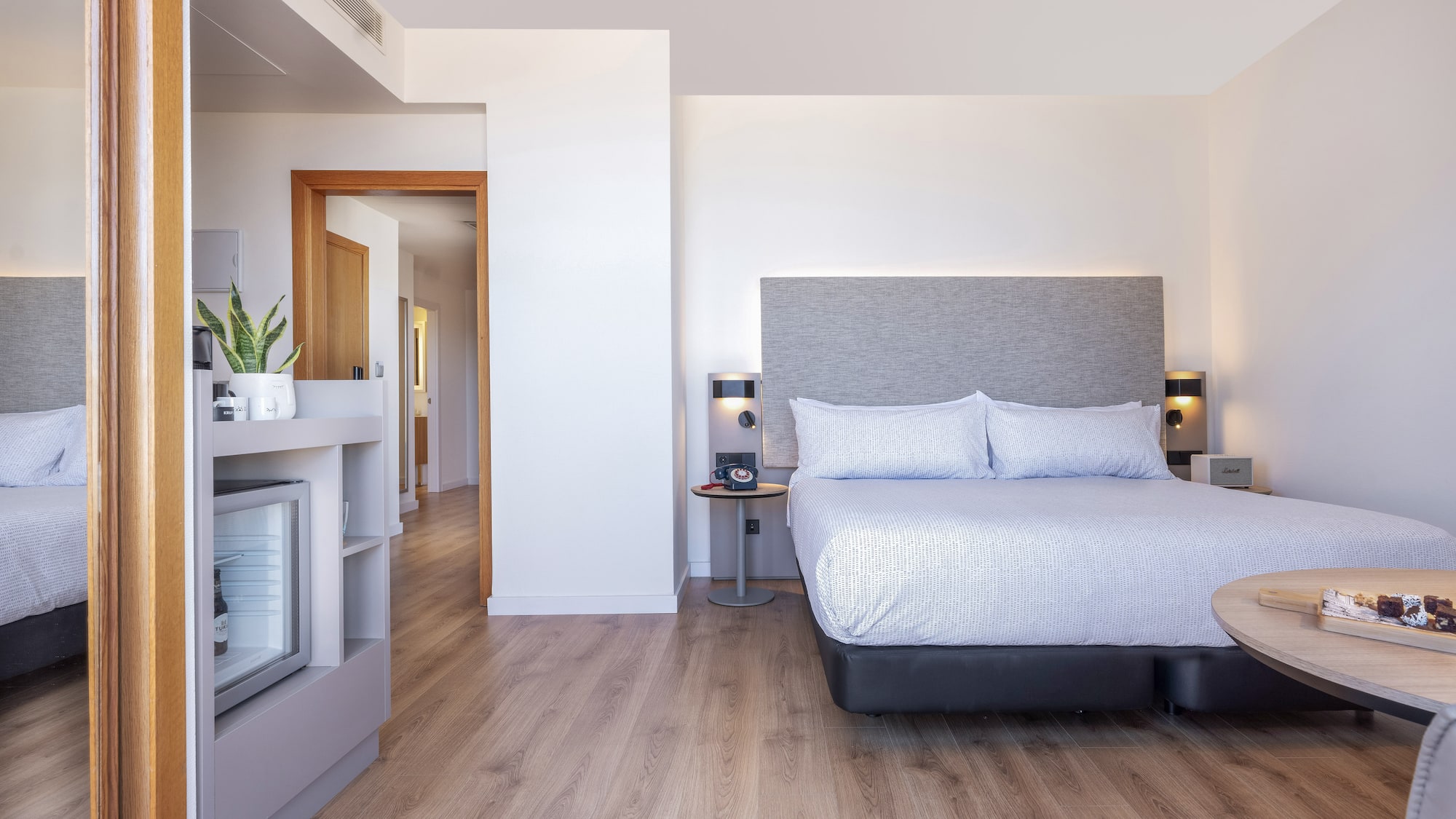 a bedroom with a bed and a wood floor